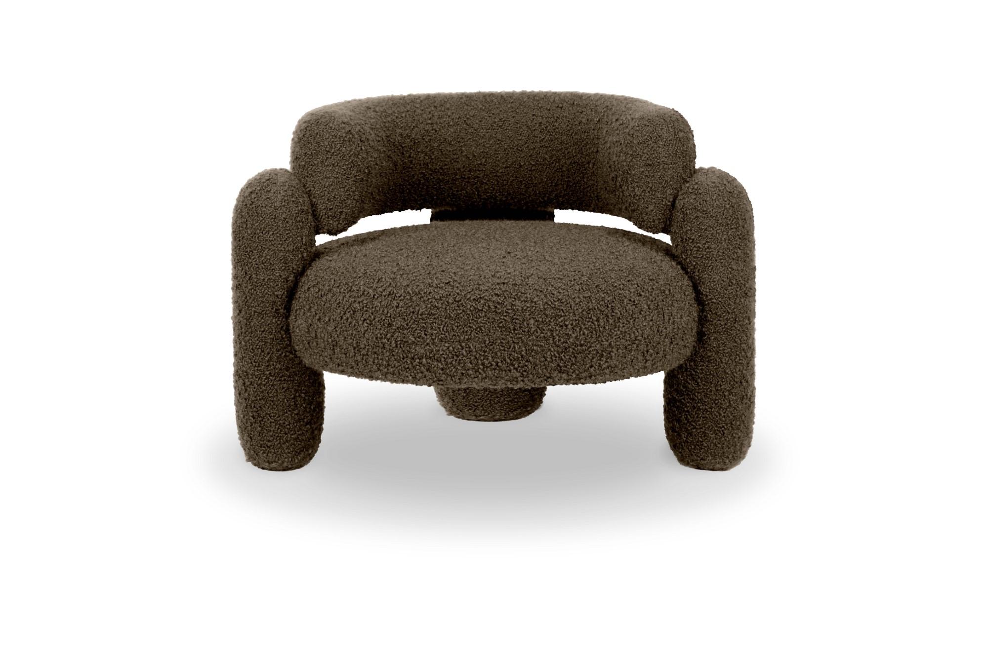 Embrace cormo chocolate armchair by Royal Stranger
Dimensions: w 96 x d 85 x h 68 cm.
Different upholstery colors and finishes are available. 

Featuring an enfolding composition of geometrical shapes, the Embrace Armchair will cozy you up in a