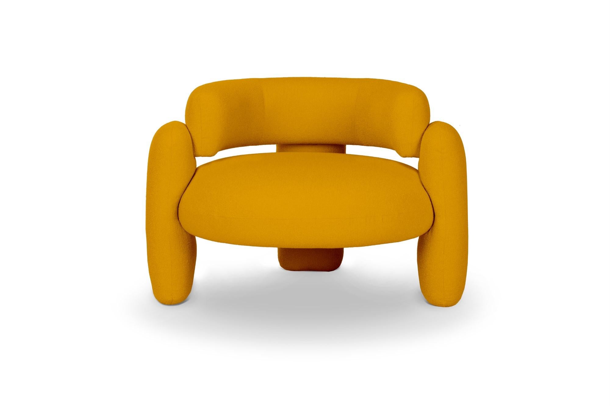 Embrace Lago Carcuma armchair by Royal Stranger 
Dimensions: W 96 x D 85 x H 68 cm.
Different upholstery colors and finishes are available.
Materials: Upholstery.

Featuring an enfolding composition of geometrical shapes, the Embrace Armchair