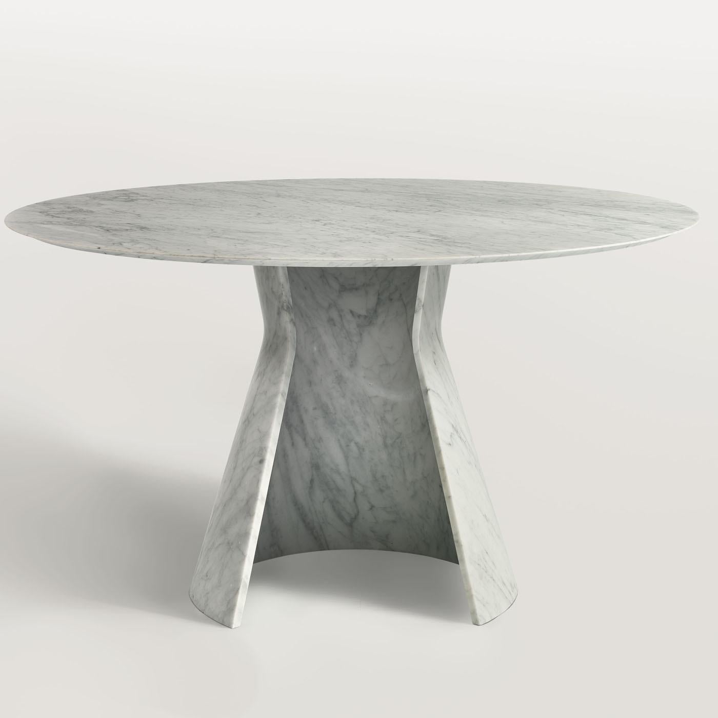 As the name suggests, this elegant table is distinctive for an enveloping base that creates a curl and raises up in a conical shape to support its round top (Ã˜ 130 cm). The base measures Ã˜ 65 cm and is made from a single piece of carved marble,