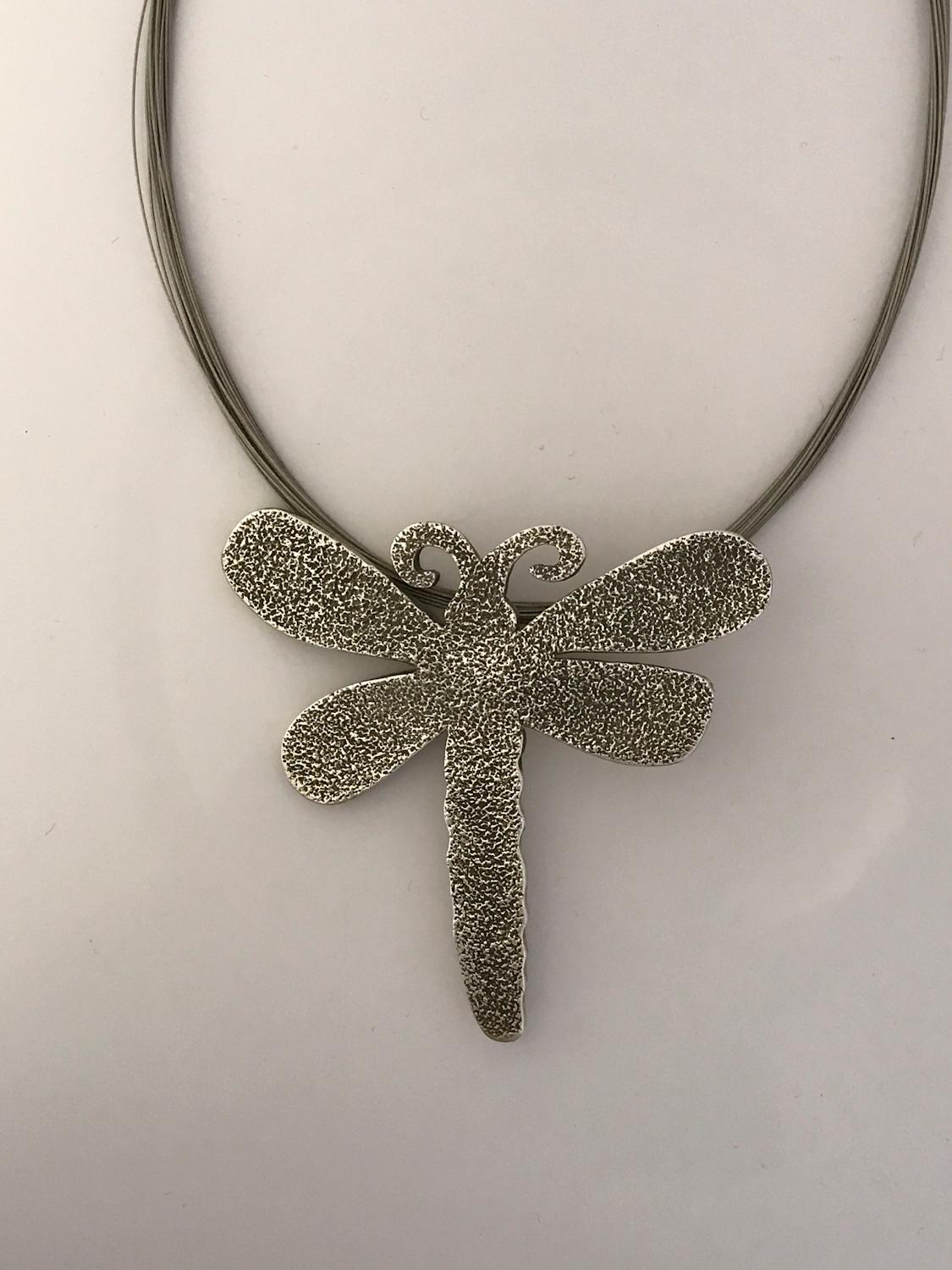 Embrace Water, Dragonfly pendant enhancer, Melanie Yazzie designs, silver Navajo

Pendant/enhancer cast sterling silver. Gently slide the enhancer over beads or a cord of your own. Beads and cords shown in the images are for sale
