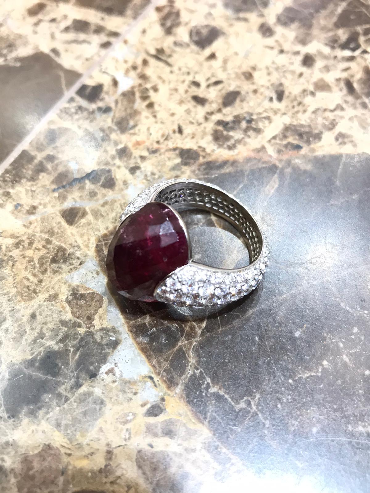 Embrace Collection by Angeletti. White Gold Ring With Rubellite Faceted and Diamonds Full Pavè.
Unique Rubellite (ct. 17.67) faceted by Expert Hands Wholly Natural, No treatment at all. Traditional Embrace Model, Designed and Manifactured in Rome.