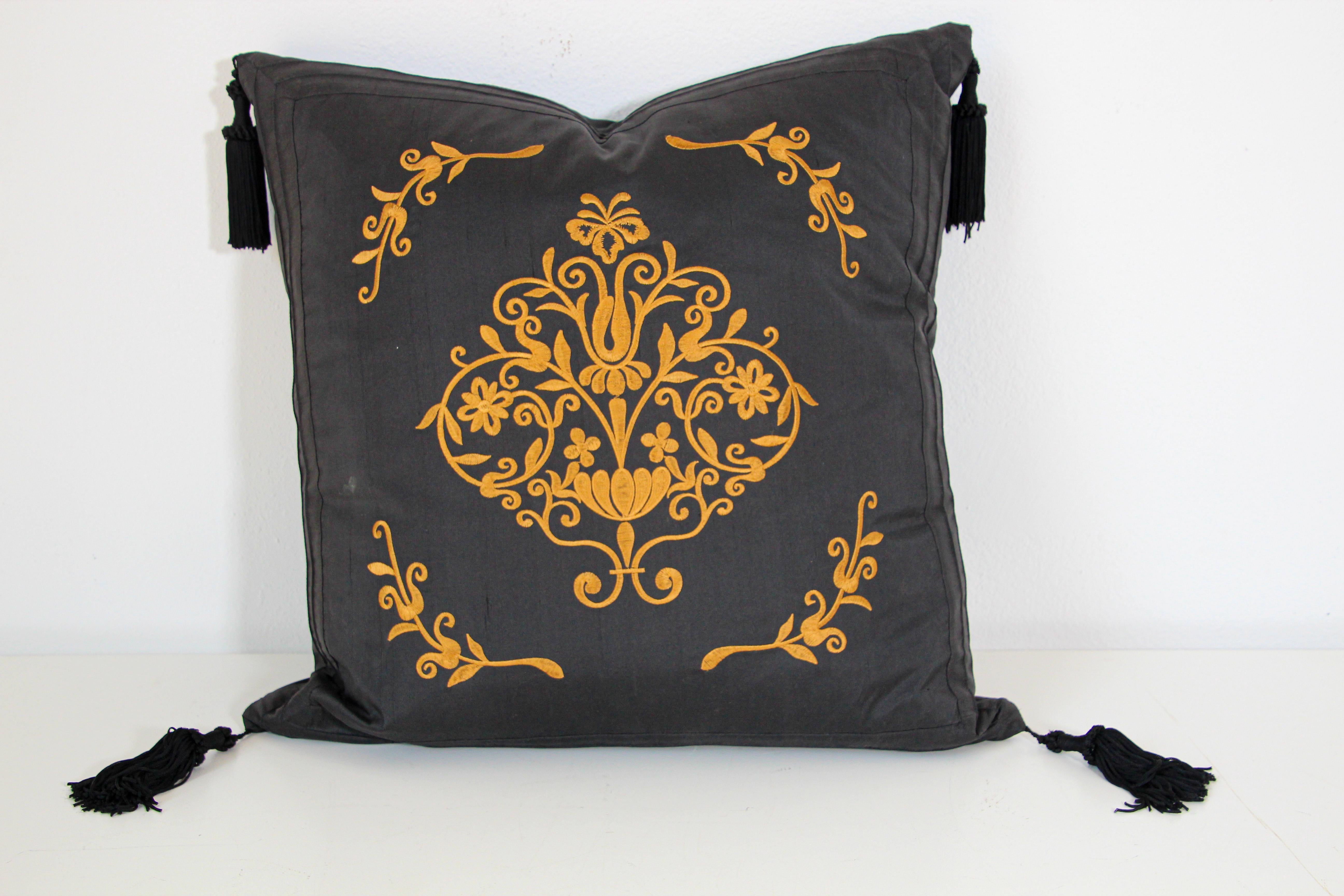 Black silk decorative accent throw pillow with tassels.
Gold embroidered silk with four large tassels.
Baroque gold floral decor embroidered in front of the pillow.