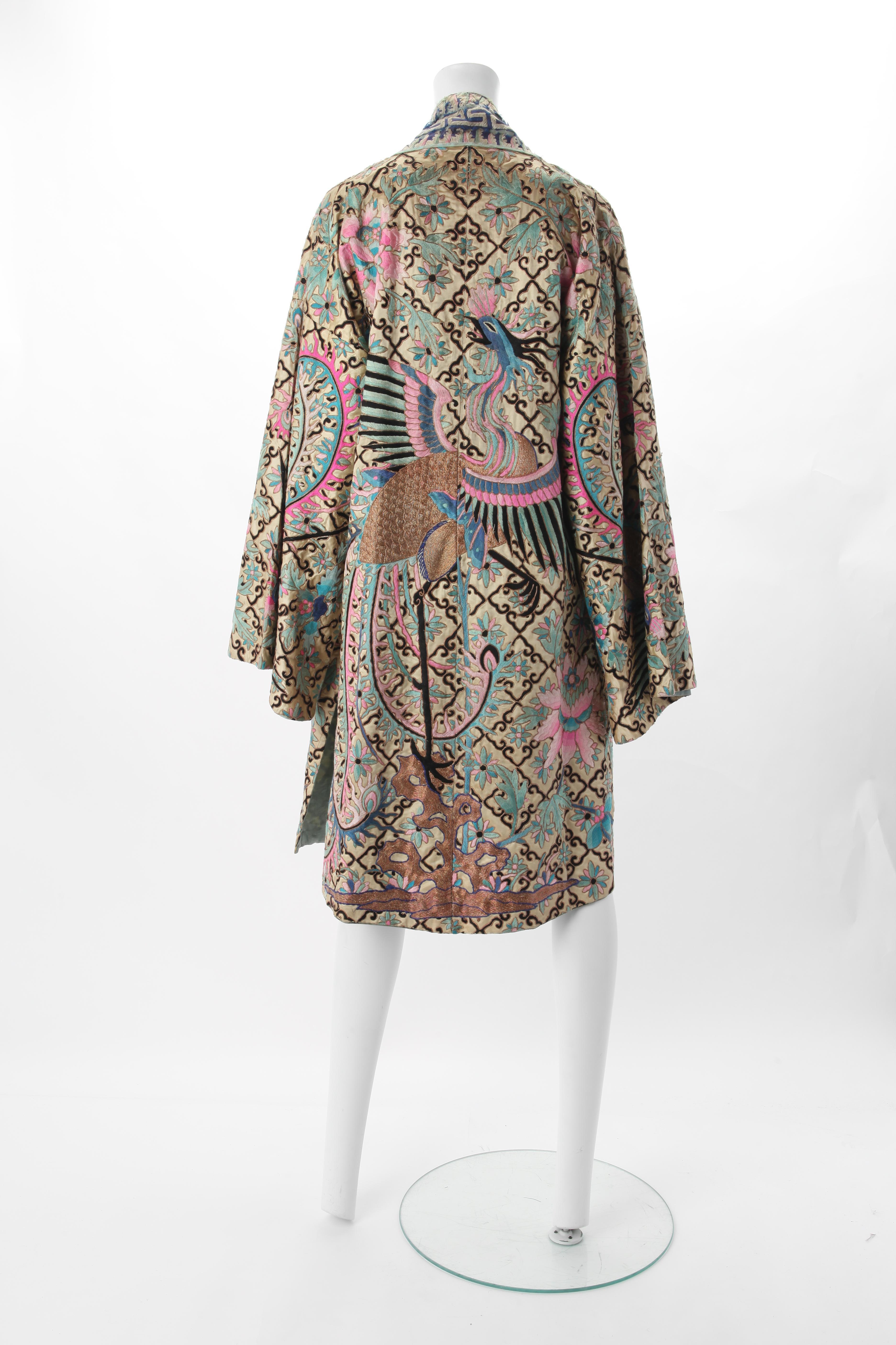 Embroidered Chinese Export Robe, Early 20th Century.
Cream silk satin robe with all over embroidery in shades of blue, pink, black & metallic gold. Dominant motif of peacock and flowers against the diamond grid.
Fits US Size 0 to 6.
