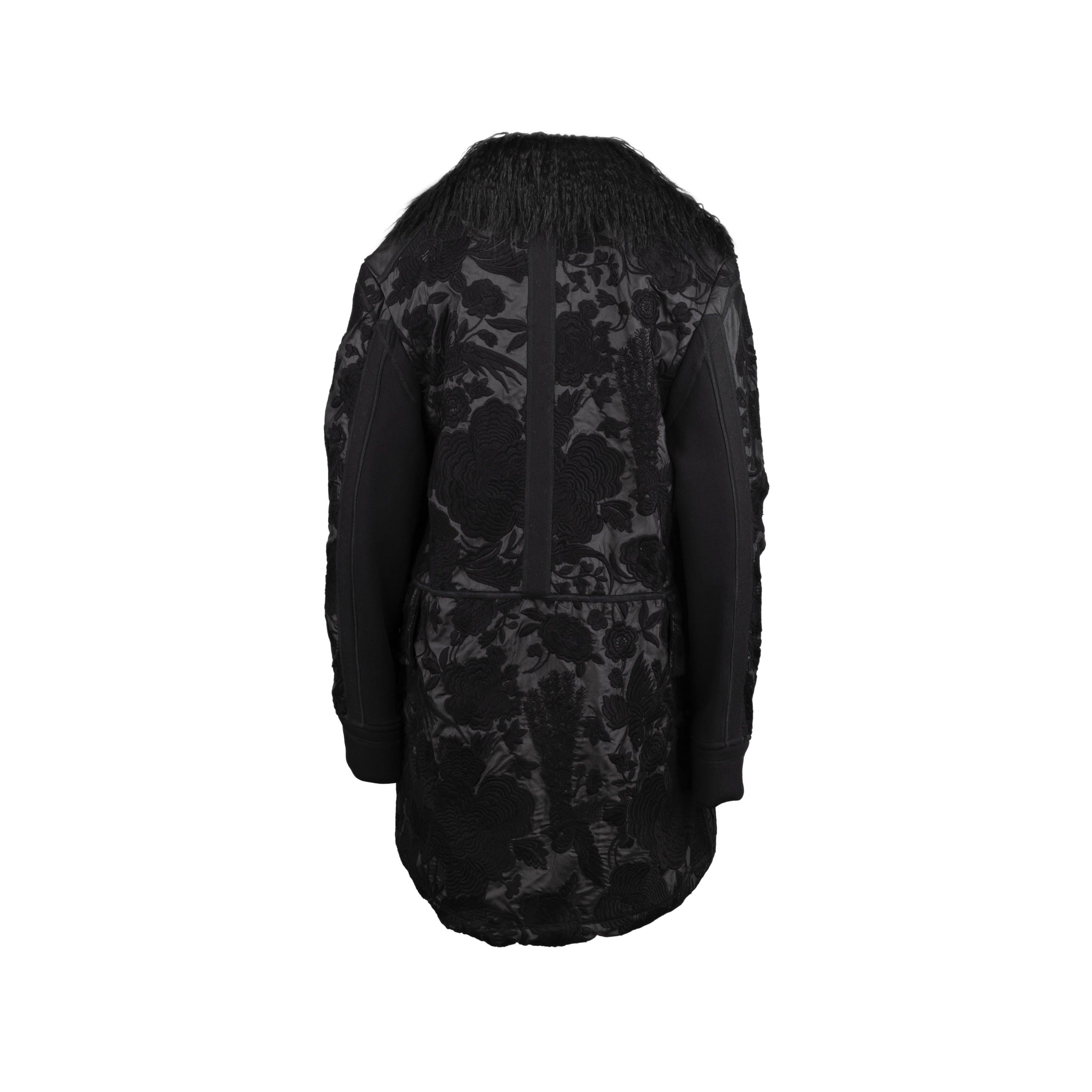 Diliborio black coat with full coverage embroidery and eco-fur inserts. Oversized style with long sleeves, maxi pockets and hook-and-eye fastening. Total length:90; Measure sleeves:67; Bust:48; Shoulders:17; Material: 100% polyester