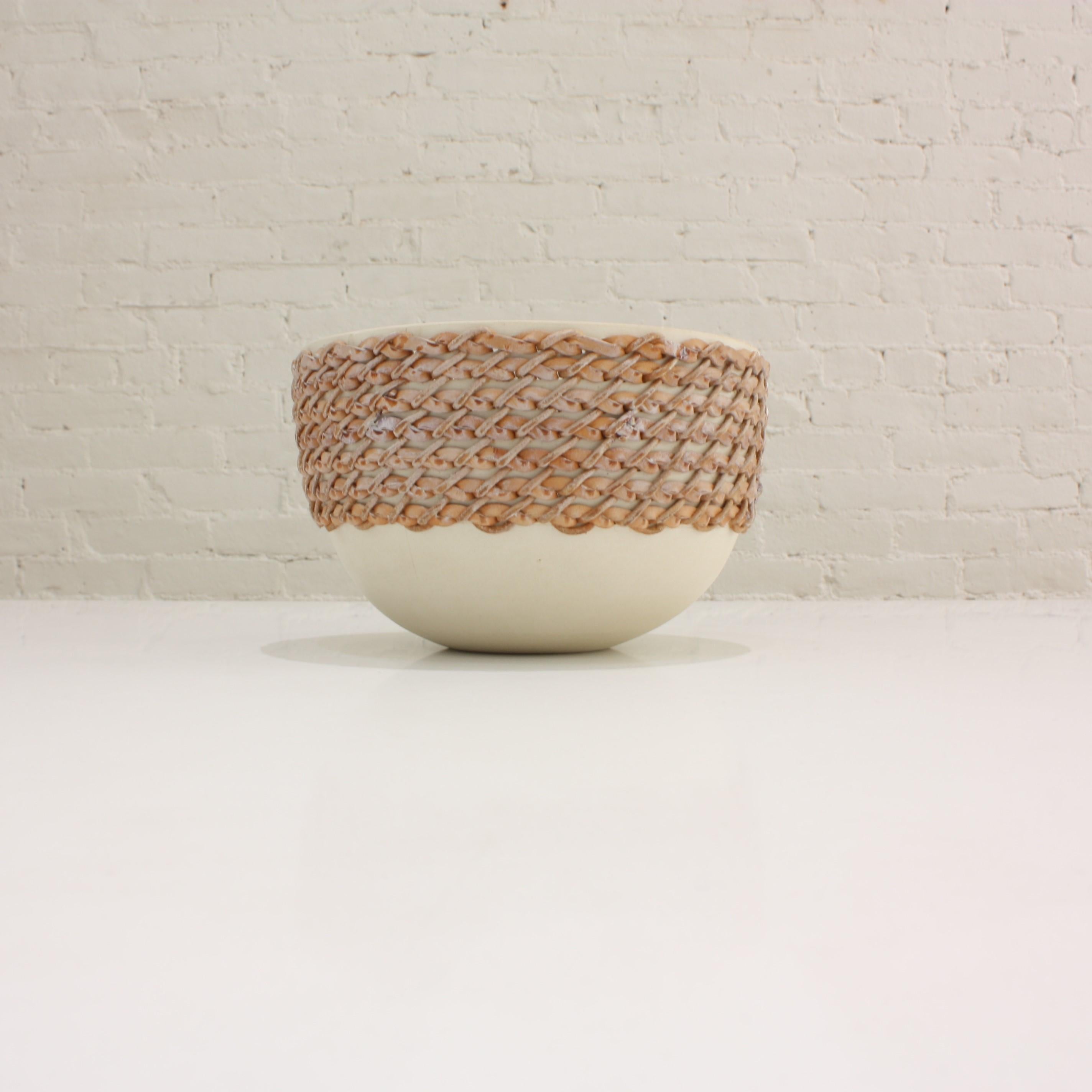 White chamotte stoneware bowl, wheel-turned, pierced and hand-embroidered with leather.

An homage to French Haute Couture, this embroidered ceramic bowl combines the artist's experience in the fashion world (Dior, Givenchy) with his passion and