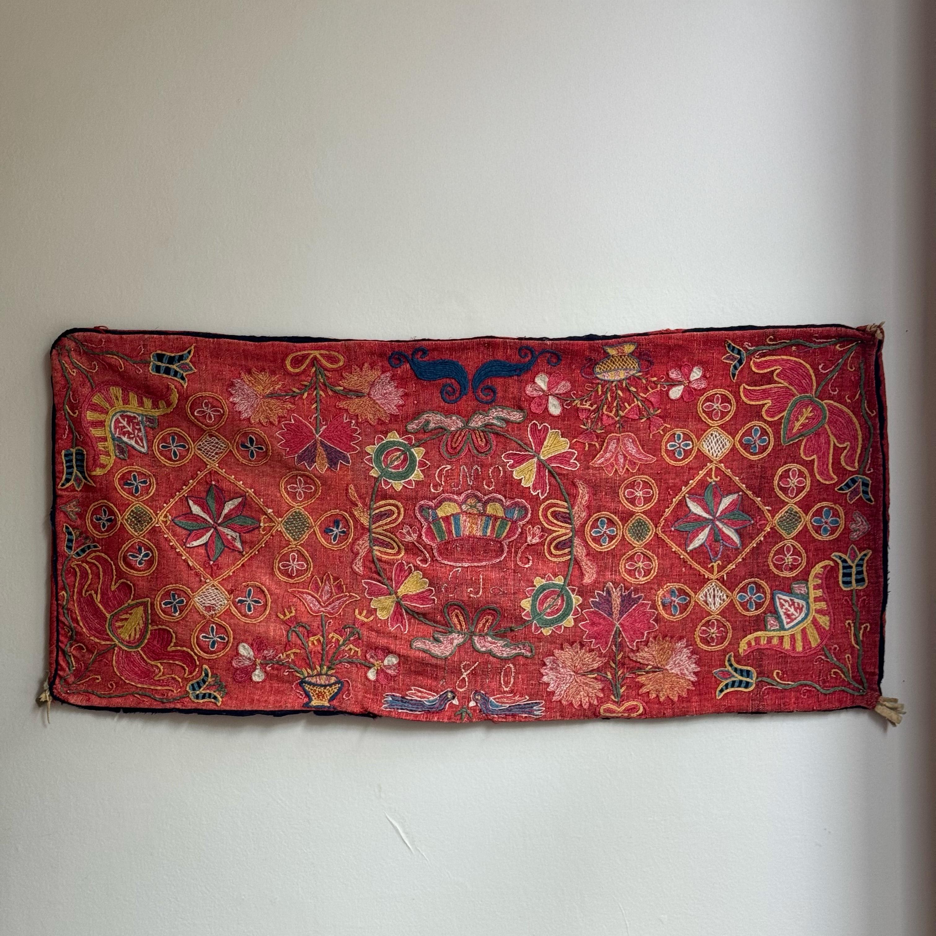 Description:

An embroidered marriage cushion made in Sweden during the early 19th century.

Dated to 1810 and saturated with dense floral embroidery, this rectangular cushion may have been created as a wedding gift or by a bride to commemorate a