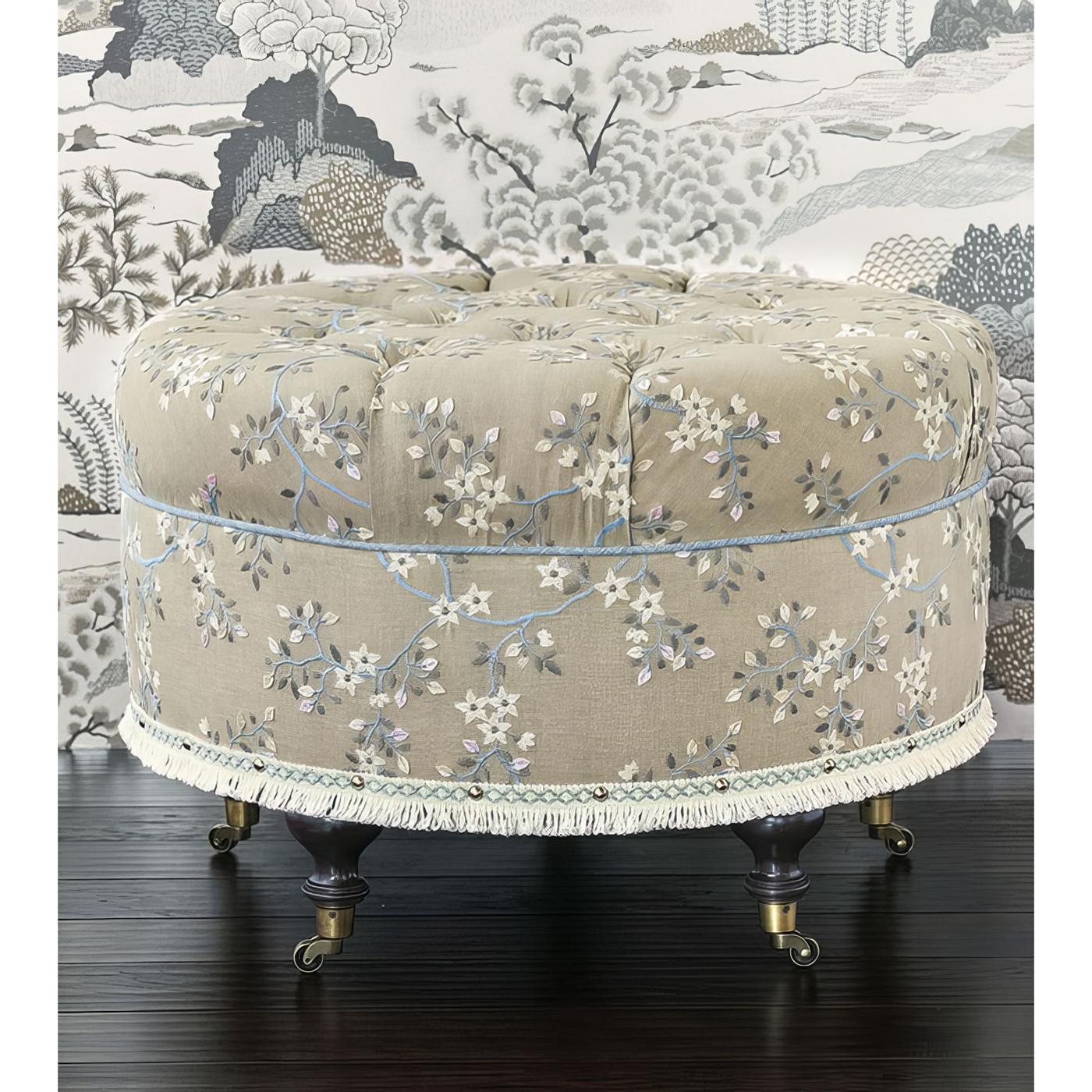  Expertly benchmade and upholstered in the USA, this exquisite vanity-height ottoman features a plush high-density foam cushion, ensuring both comfort and support. The luxurious 100% cotton floral embroidered fabric is hand-tufted with