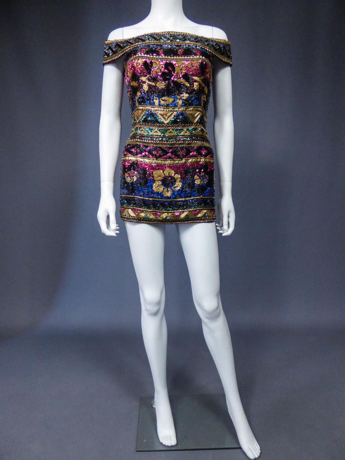 Late 1980
Italy Milan

Sleeveless evening tunic embroidered with spangles by Mila Schön (attributed to) probably dating from one of her Couture fashion shows of the 1980s. Embroidery of spangles, pearls and tubular sequins by flowery and