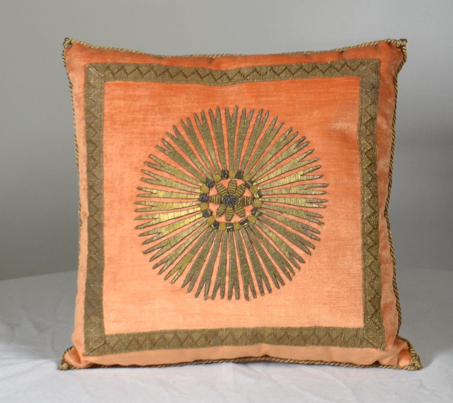 Antique ottoman empire raised gold metallic embroidery depicting a star burst framed with antique gold gallon on melon velvet, hand trimmed with vintage gold metallic cording knotted in the corners. Measures: 15