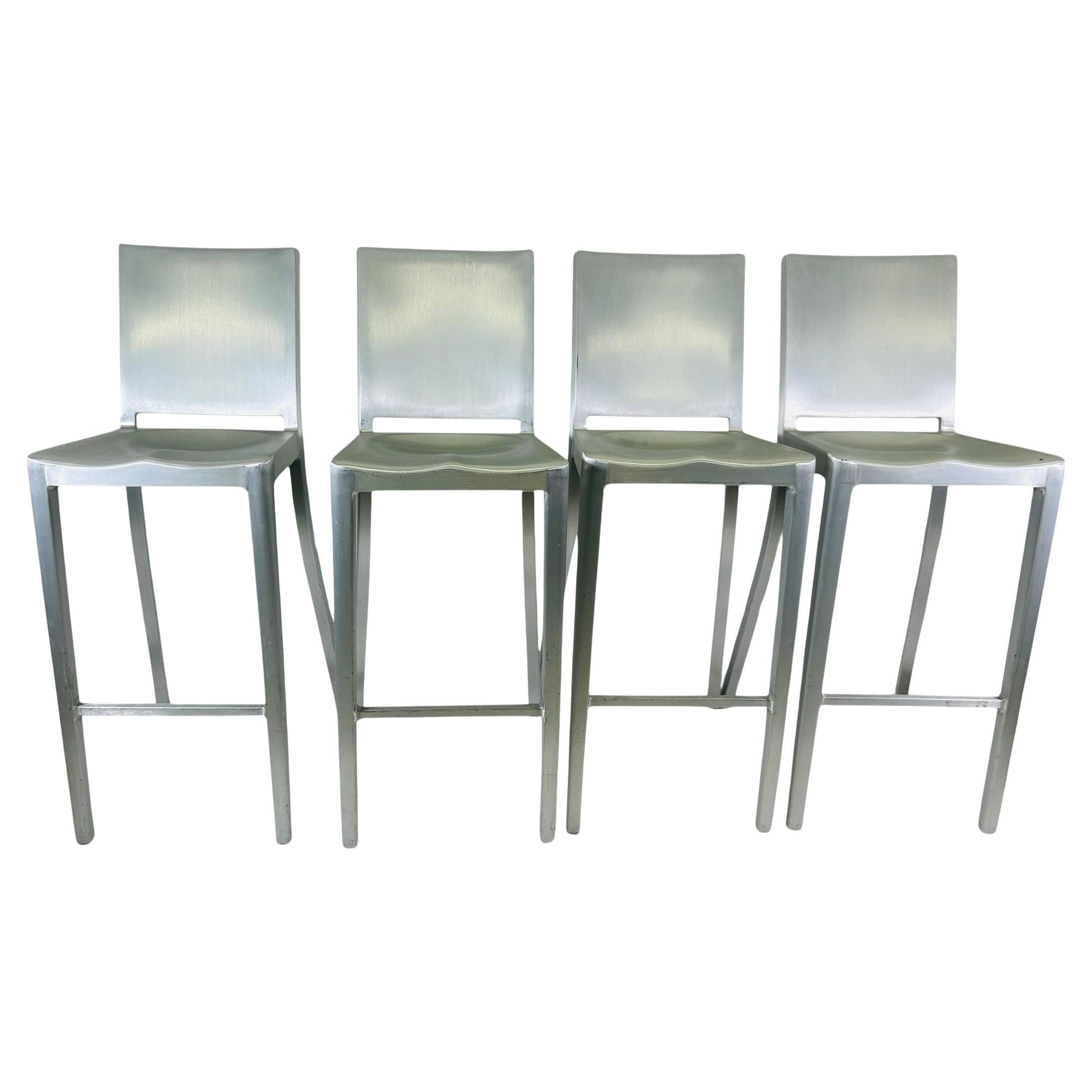 These 4 Emeco Navy Stool's were designed by Philippe Starck.  The EMECO Navy chair original bar stool was created in 1944 for the US Navy as a lightweight, non-corrosive, fire resistant and super strong chair for ships and submarines. Indoor/Outdoor