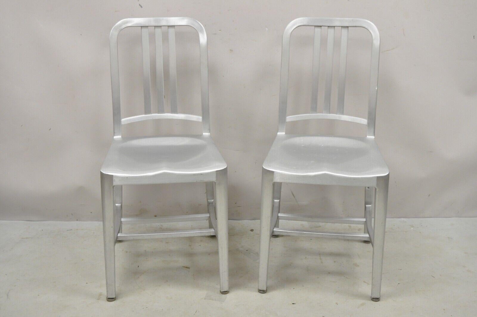 Emeco Navy Collection Brushed Aluminum Side Chair 1006 - A Pair. Item features aluminum construction, original labels, very nice vintage item, quality American craftsmanship, great style and form. circa 21st Century, Pre-Owned. Measurements: 34