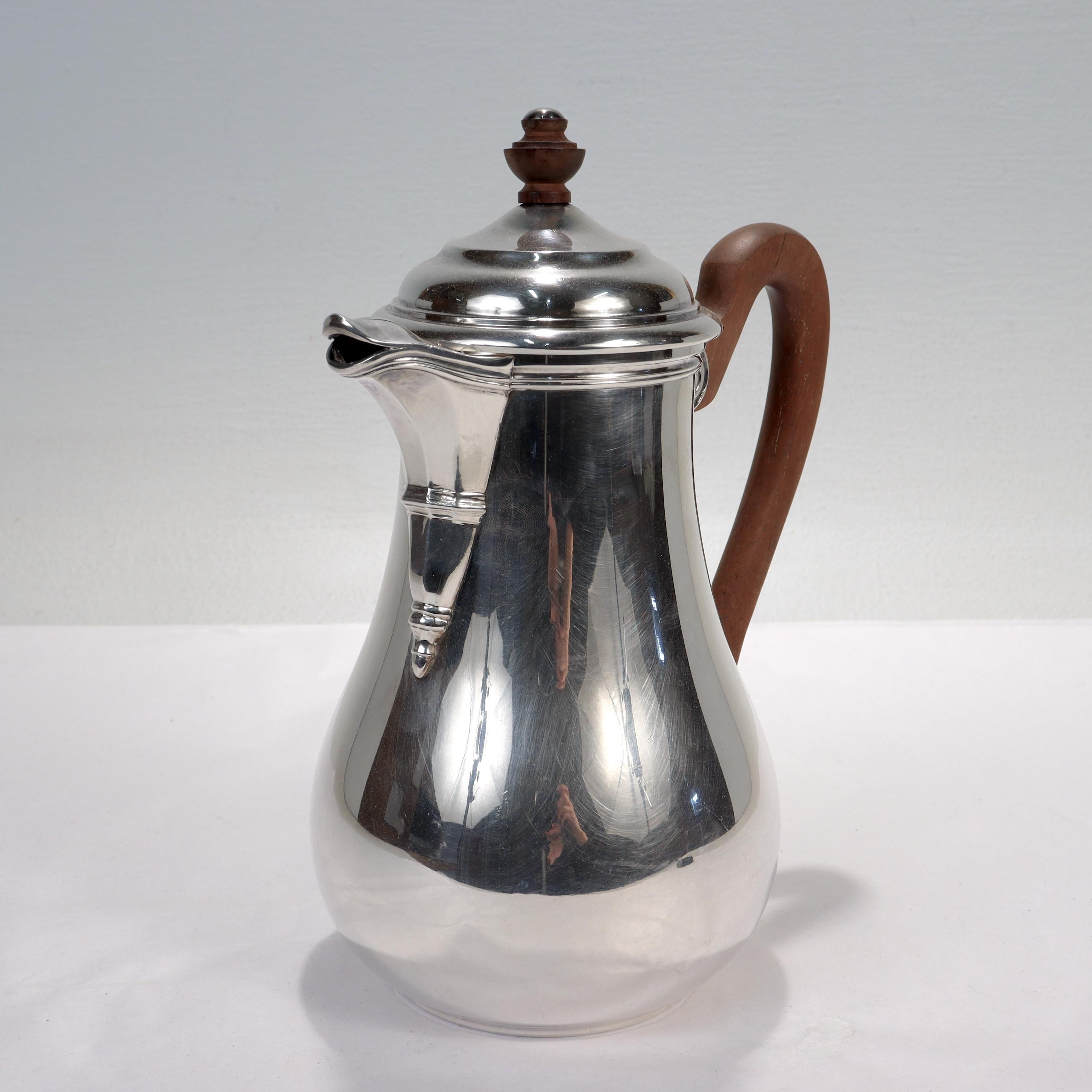A fine French silver plate coffee pot.

By Puiforcat.

With a vasiform body, molded spout, and attached wooden handle.

Marked to the base 'Puiforcat France' and hallmarked to the side with an 'EP' maker's mark.

Simply the highest