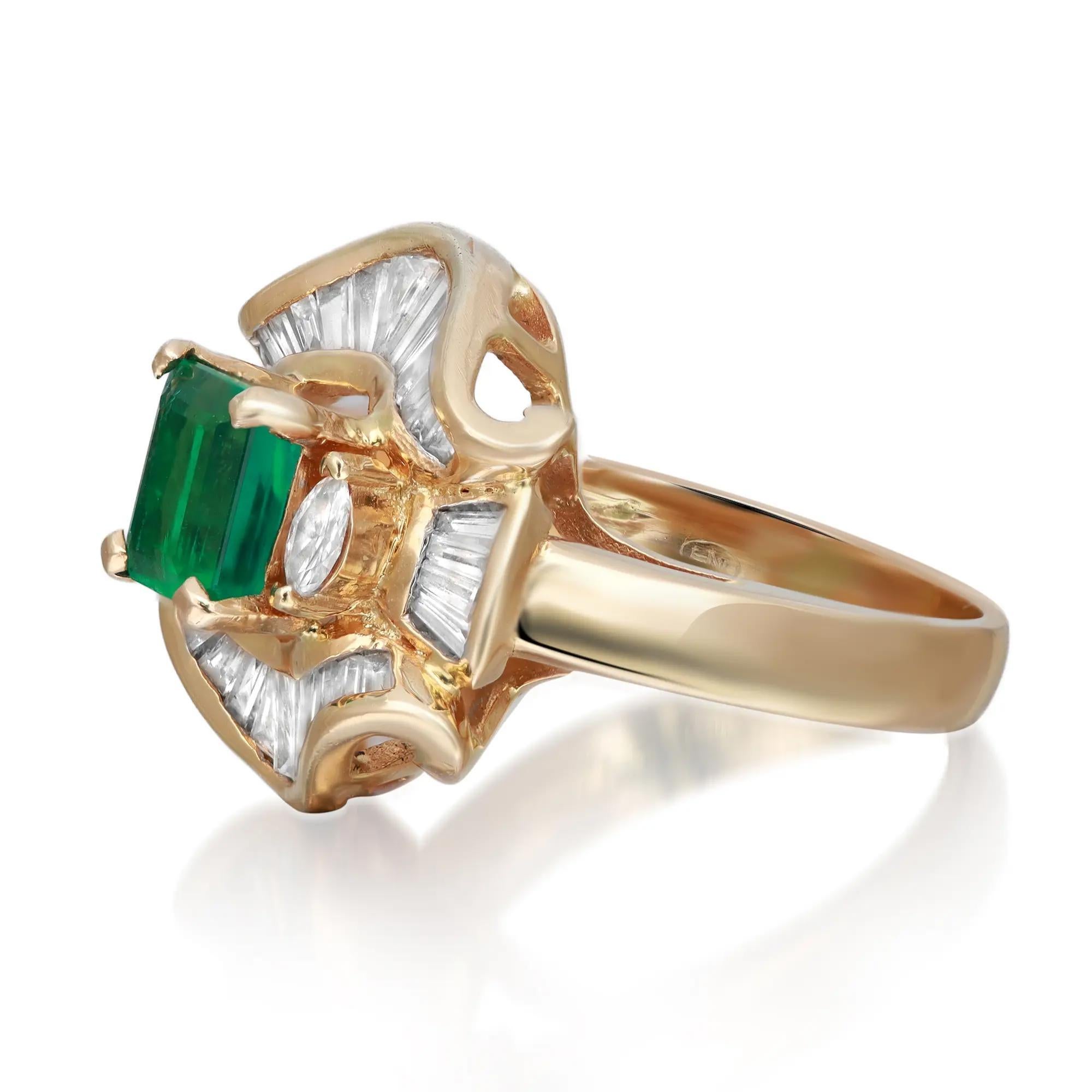 This stunning cocktail ring features prong set emerald cut green emerald which is accented with two prong set marquise on both sides and baguette cut diamonds around the center stone mounted in 18k yellow gold. The gemstone is rich in color and