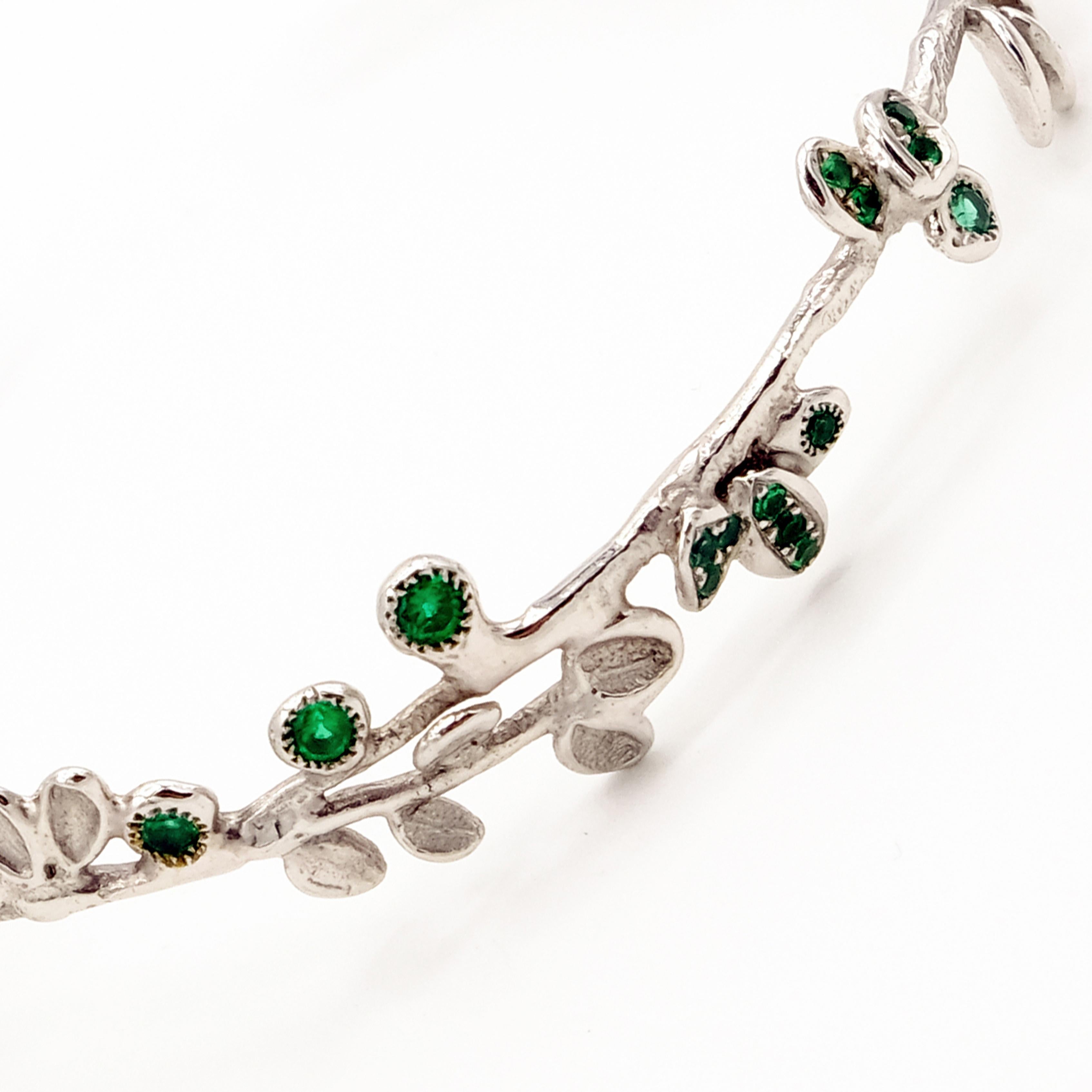 This one-of-a-kind bracelet is expertly crafted by hand from 18 Karat White Gold and weighs approximately 10 grams. It is set with Emeralds in total approximately 0.59 carat.

The craftsmanship is entirely hand made with great care, in my Parisian