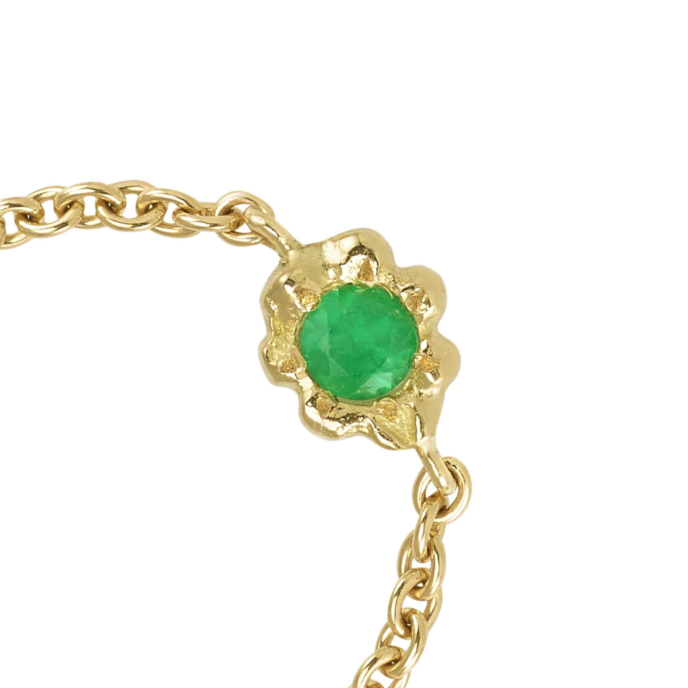 This ring is handmade in 18 Karat Yellow Gold. It is set with an Emerald, approximately 0.3 carats. The ring band is a chain that is moveable in order for it to position itself nicely on the finger for real comfort. Its weight is 1 gram