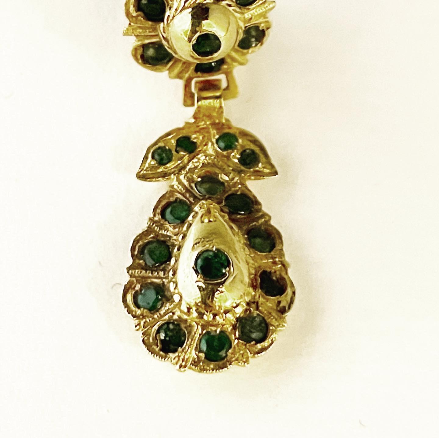 Exquisite emerald earrings crafted in 18k yellow gold.
Round cut emeralds set high in the gold mounts in the traditional forms of this Spanish region.
Clip-on.
Attractive and not heavy in weight due to their construction.

FREE SHIPPING.
RETURNS