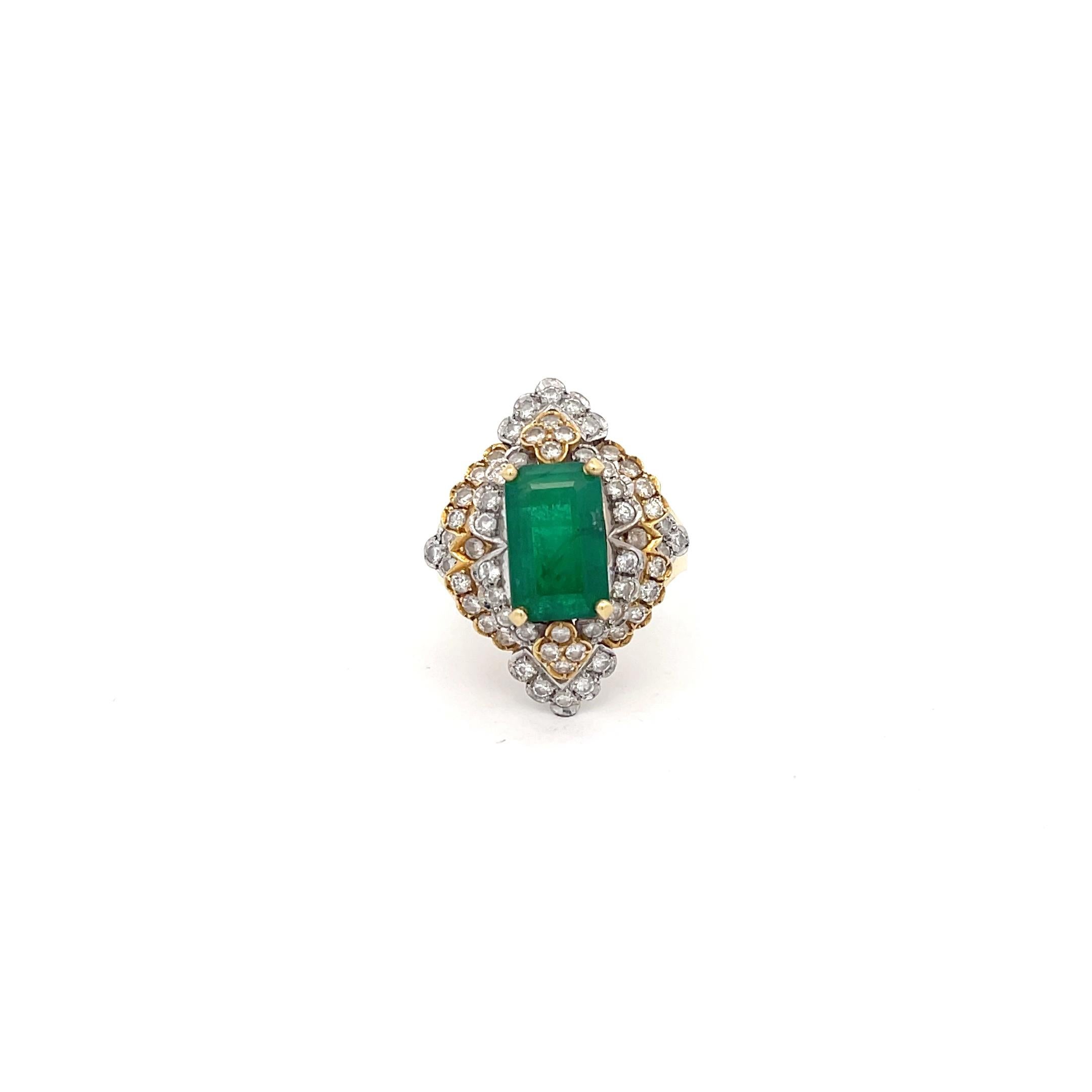 Emerald and Diamond Ring in 18K  Gold. The ring features an emerald in the center that is approximately 2.25ct, accented by approximately 1.50ctw of round diamonds. Ring size 7, and weighs 9.8 grams.