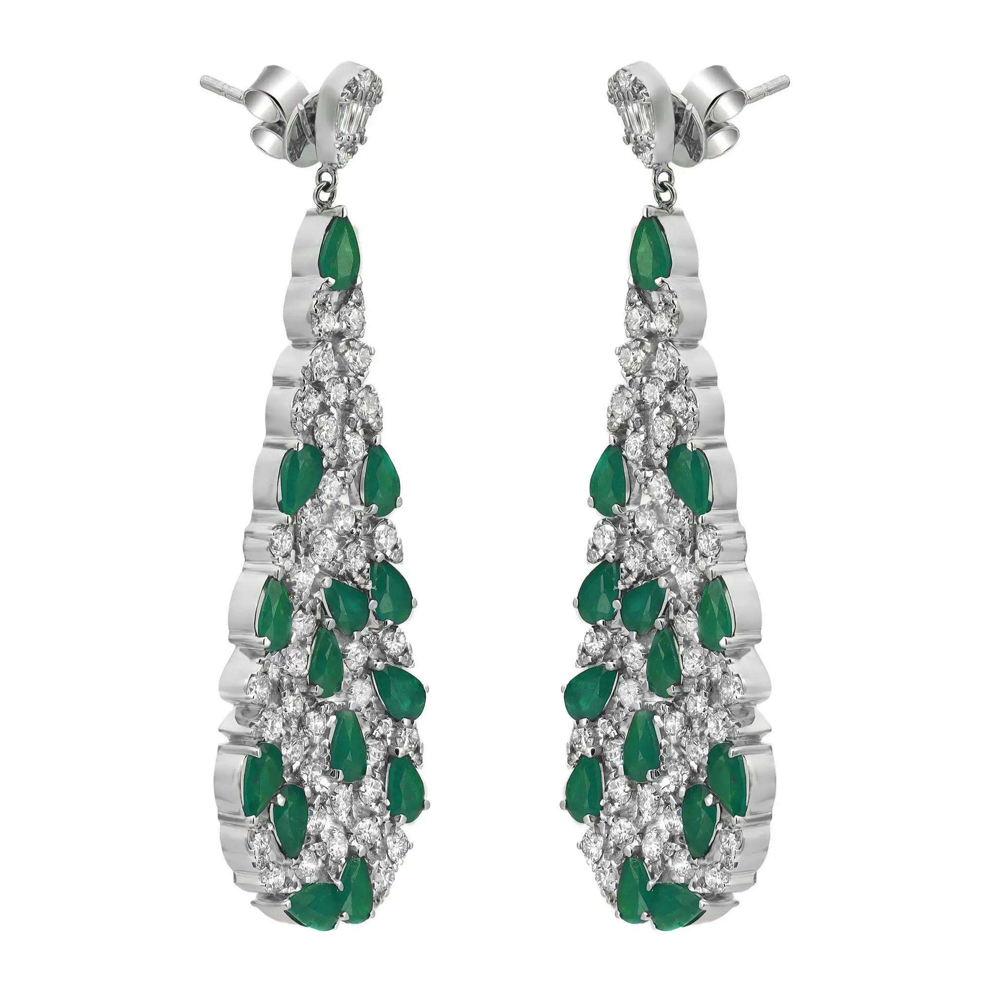 Shimmering emerald and diamonds sway along these stunning 14K white gold women's drop earrings. These earrings feature prong set pear cut emeralds and round brilliant cut diamonds encrusted in a pear shaped mounting hanging from a small pear shape