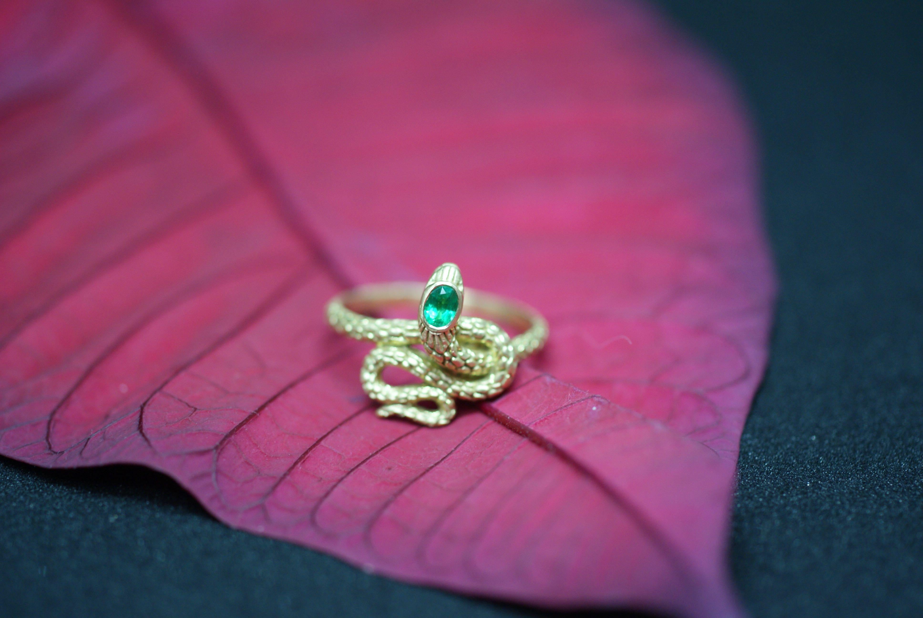 Serpents have historically been used as symbols of protection. Think of all the imagery of serpents guarding treasures. This charming ring is set with an oval-cut emerald in the head of the serpent and is manufactured in 18K gold. This ring is 100%