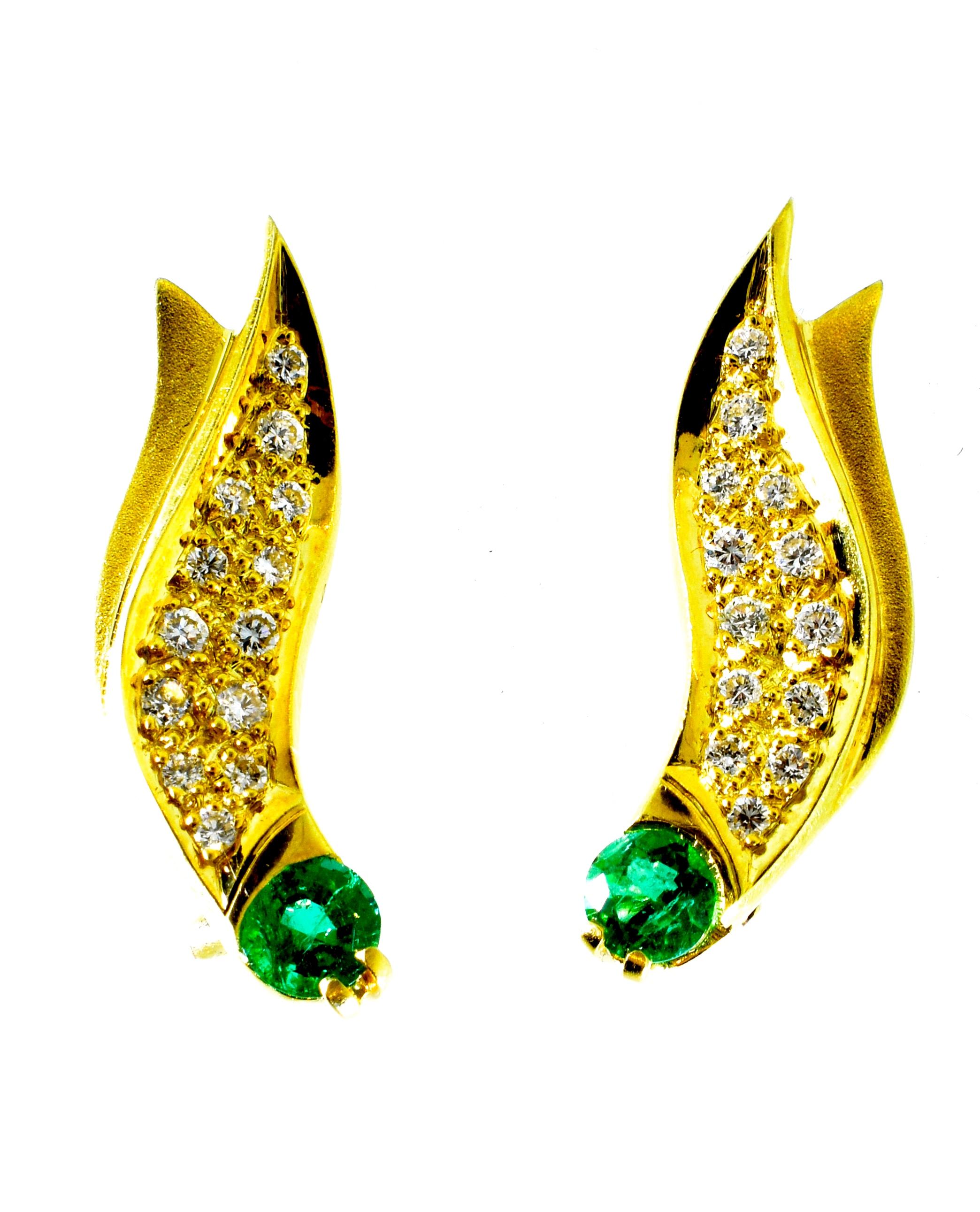 Emeralds, prong set in an 18K yellow gold flame like motif.  There are 26 fine white round brilliant cut diamonds weighing an estimated .50 cts.  These well matched and well cut diamonds are H in color (near colorless), and very slightly included