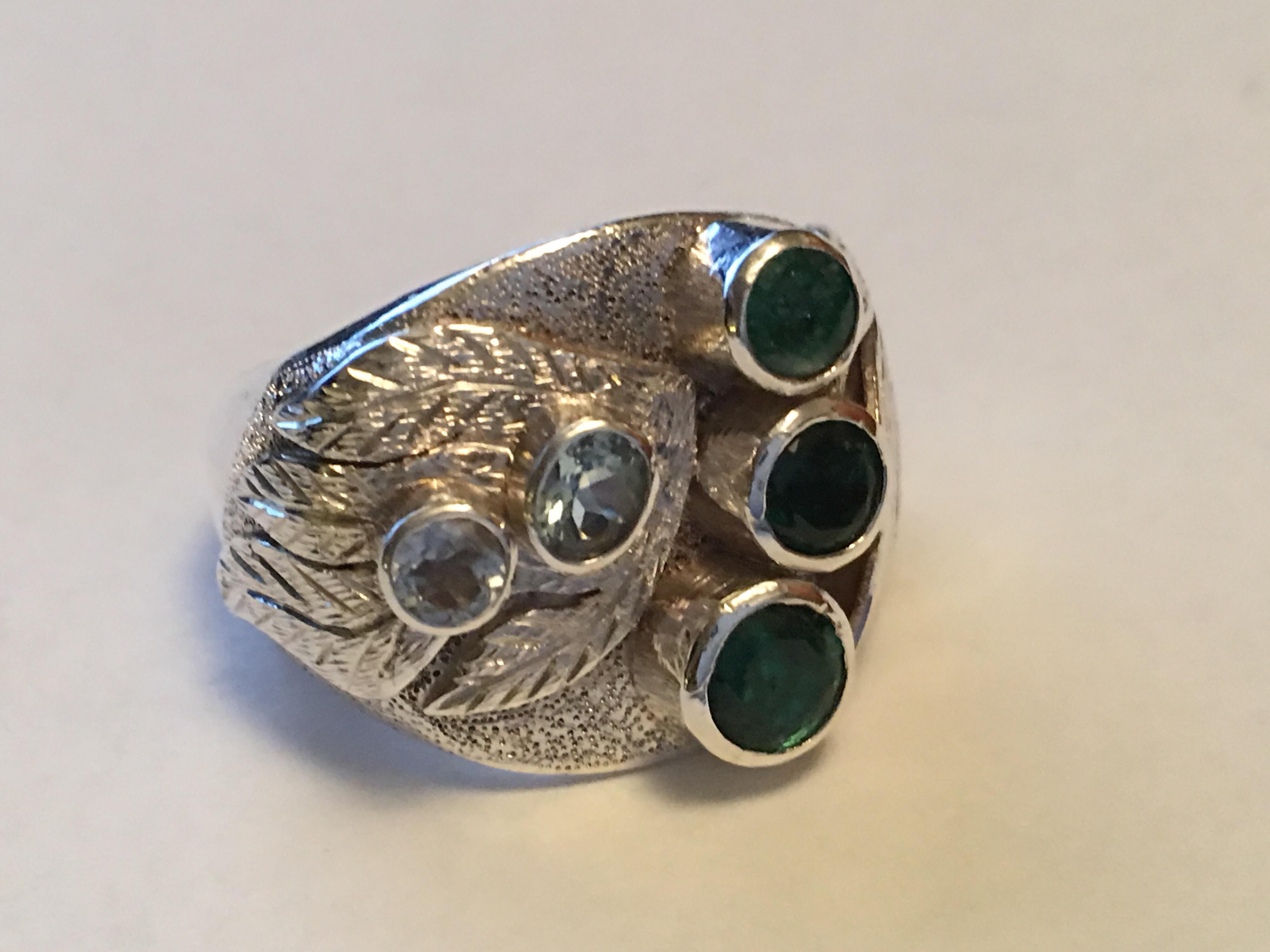 Hand crafted one of a kind sterling silver ring.
5 MM Round and other two are 3.5 MM Natural Emerald with two aquamarine.
Solid ring is unisex,
Size of the ring is 8.5 but can be resized.
