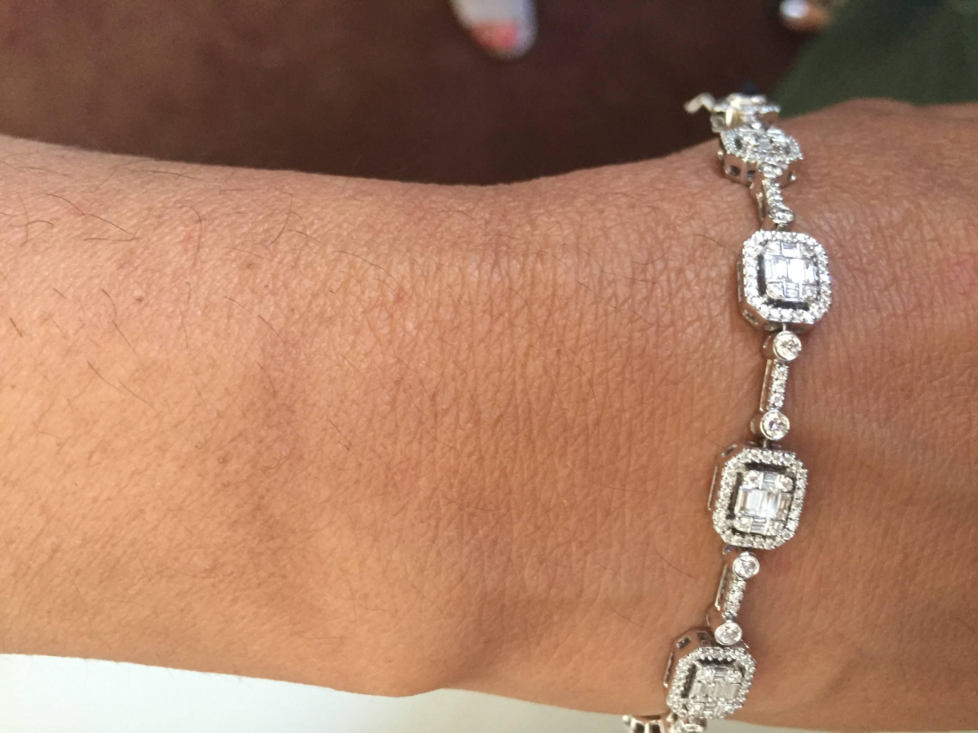 Stunning bracelet set in 18K white gold. Bracelet set with sections of emerald cut illusion. A classic piece with and Art Deco look. This illusion bracelet is set with multi-cut emerald, baguette and round diamonds. The color and clarity is F, VS1.