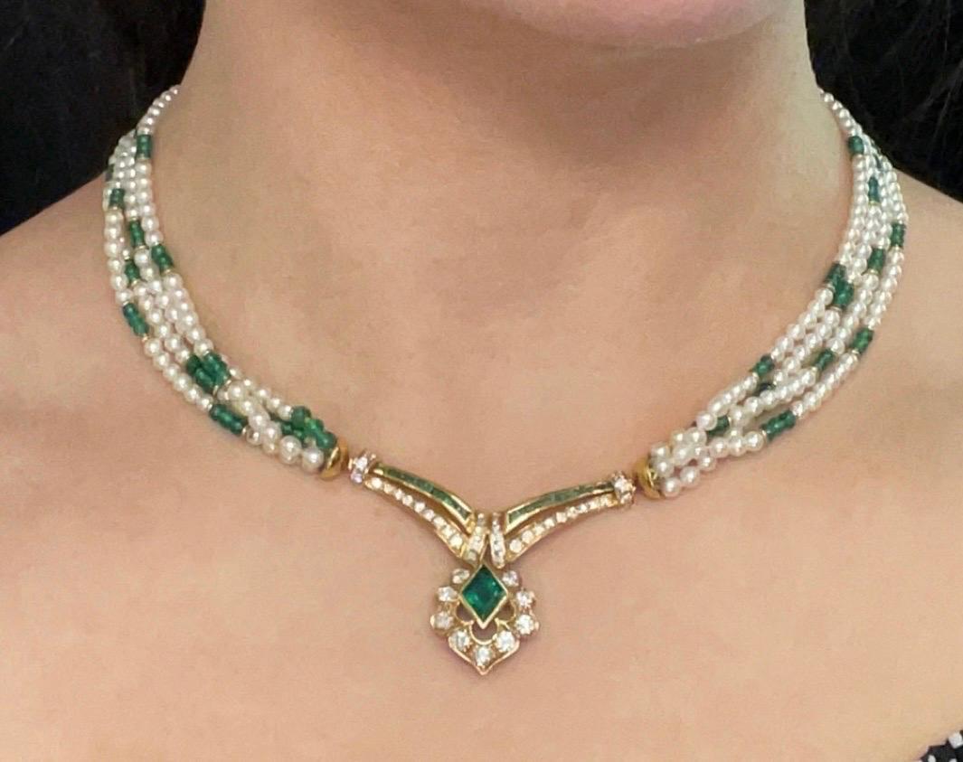 Emerald and Cultured Pearl Necklace

A four-strand necklace with cultured pearls and 135 emerald beads separated with gold spacers. It features a center gold pendant adorned with mixed-cut diamonds and emeralds. 

Approximate Stone Weights: 
Center