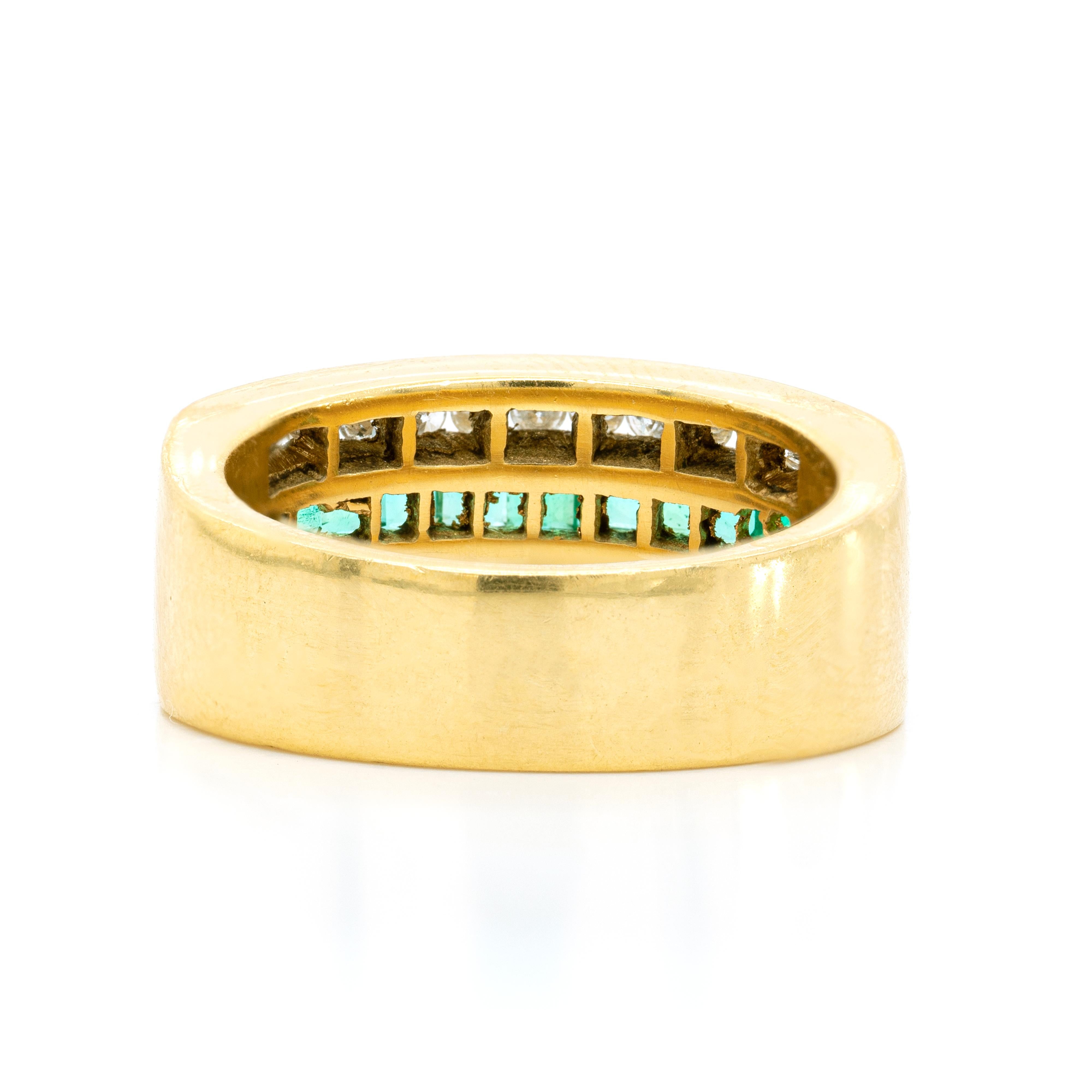 This 18 carat yellow gold band ring is beautifully inlaid in the centre with a row of eleven square cut emeralds, weighing an approximate total weight of 0.70ct. The vibrant emeralds are highlighted on either side by a row of thirteen channel set