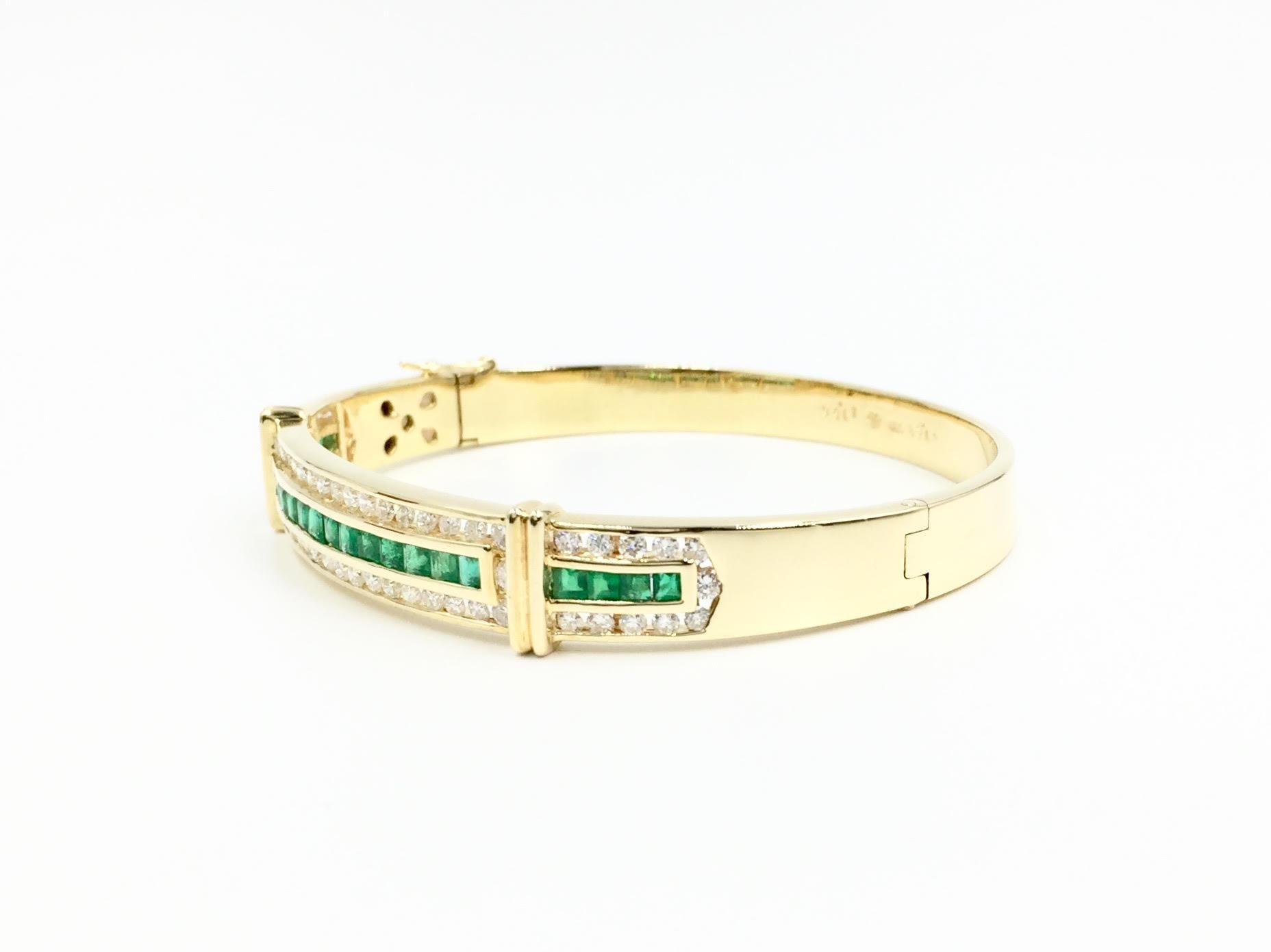 This 18 karat yellow gold emerald and diamond oval shaped bangle bracelet features 1.63 carats of bright round brilliant diamonds and 1.66 carats of vibrant genuine emeralds. Diamonds have an approximate color and clarity of F, VS2. Bracelet has a