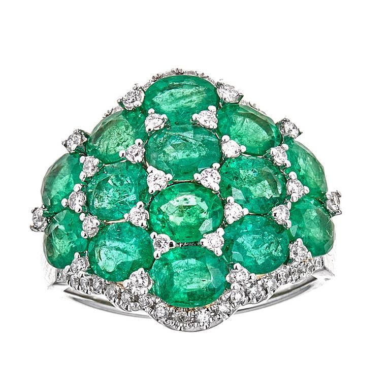 18 Karat White Gold 4.58 Carat Oval Emerald and Diamond Designer Cluster Ring

Stylish and elegant. This ring showcases vividly green oval-shaped emeralds encrusted on top of the wideband, accented by small round diamonds of high quality. Buffed to