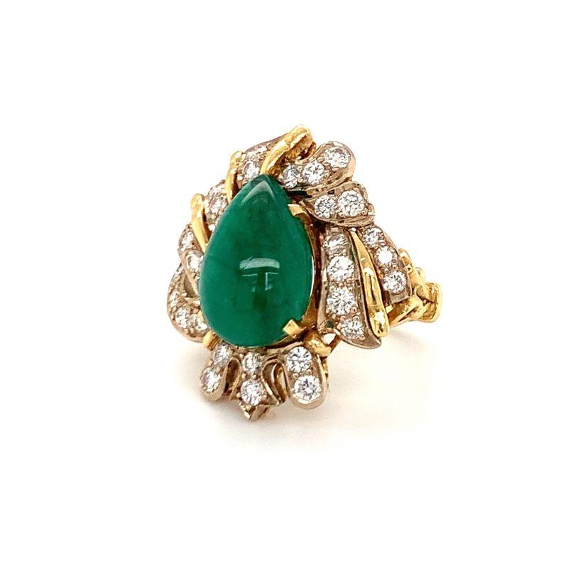 One emerald and diamond 18K yellow gold ring featuring one pear cabochon emerald weighing 9.50 ct. surrounded by 33 round brilliant cut diamonds weighing 1.50 ct. Ring measures 28 x 26 millimeters across the top portion. Circa 1960s.

Appealing,