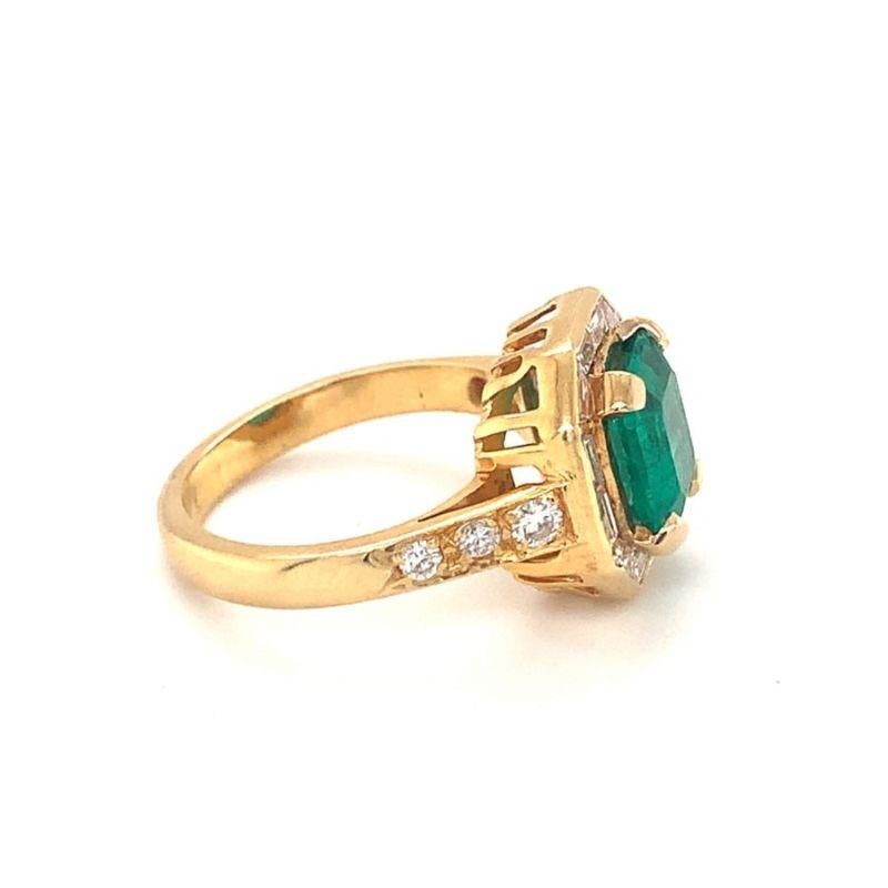 One emerald and diamond 18K yellow gold ring featuring one square emerald cut emerald weighing 2.15 ct. measuring 8 x 8 millimeters in size. Enhanced by 18 straight baguette and round brilliant cut diamonds totaling 0.85 ct. Circa 1970s.

Chic,