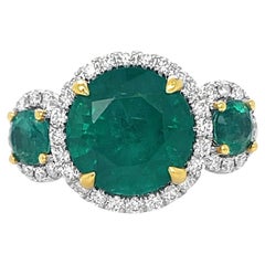 Emerald and Diamond 3 stone halo Ring in 18K Yellow and White Gold 