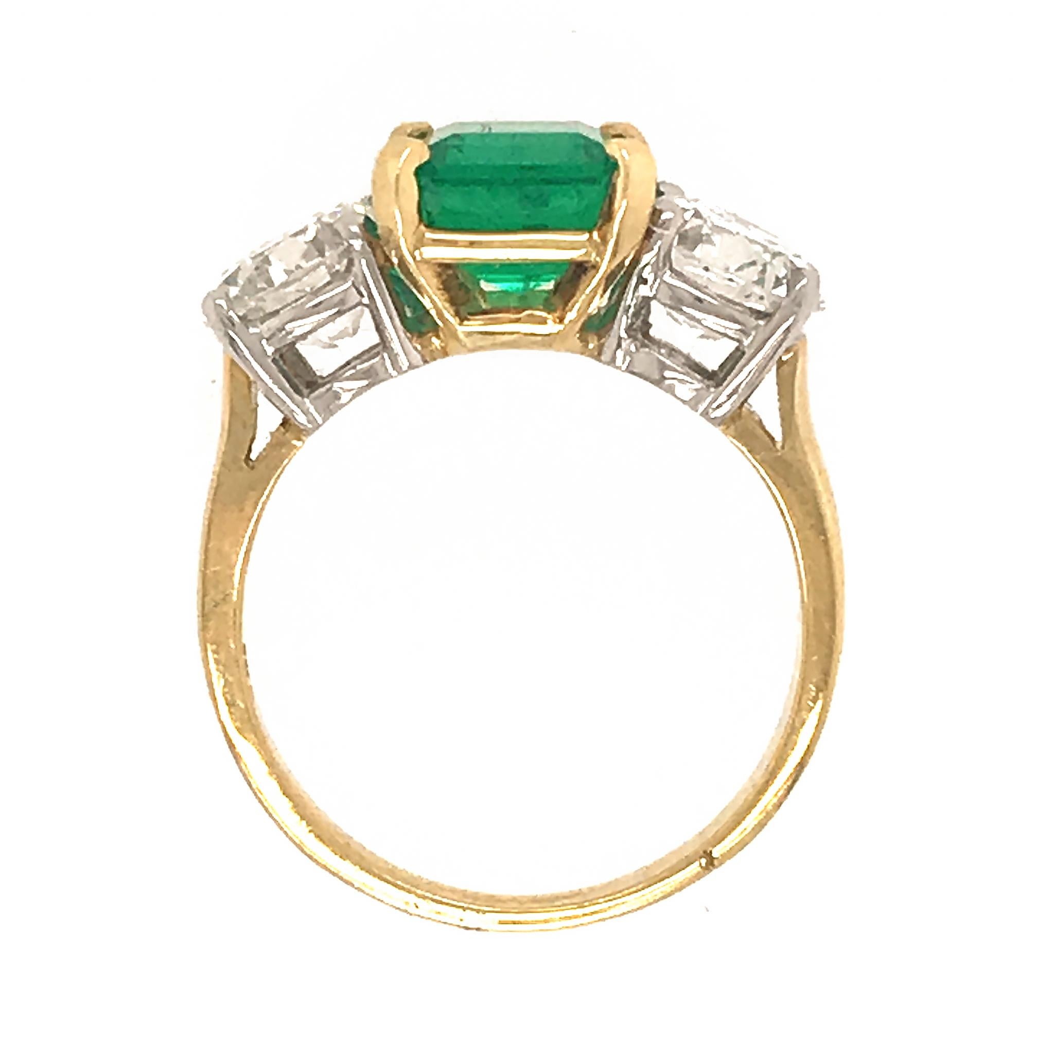 18k White and Yellow Gold Mounting.  
The beauty of the Emerald is highlighted by the white side diamonds. 
Diamond: 2.50 ct twd
Emerald: 2.00 tcw (estimated)