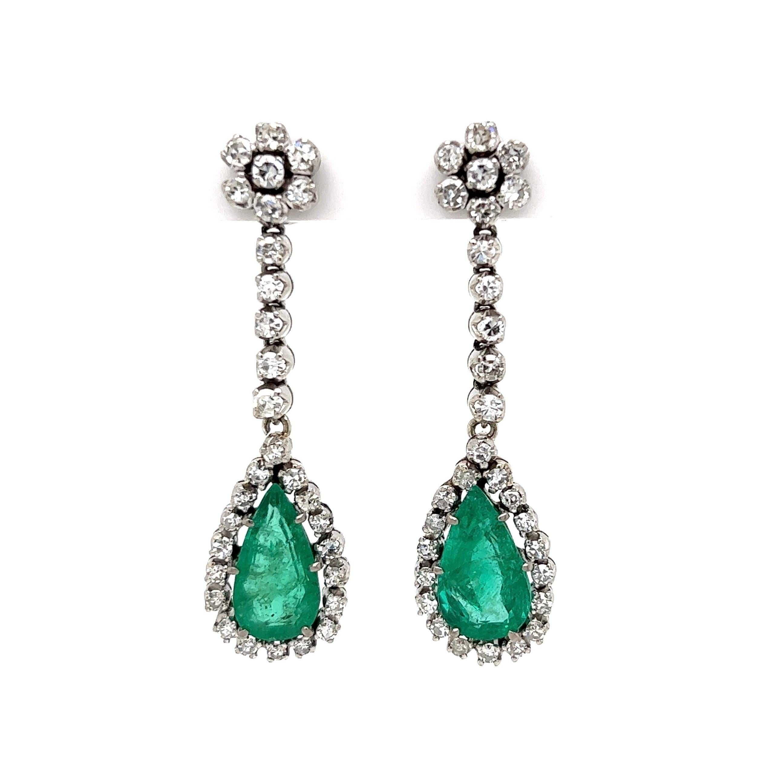 
Simply Beautiful! Finely Detailed Art Deco Style Diamond and Emerald Drop Earrings. Hand crafted in 18K White Gold and Hand set with, 60 Single-Cut Diamonds weighing approx. 2.00tcw and Pear-shaped Emeralds approx. 4.50tcw. Earrings measuring