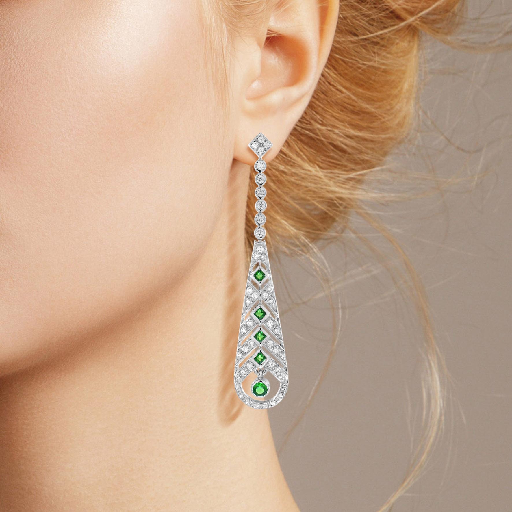 A fabulous pair of emerald and diamond Art Deco design earrings. Typically Deco, these wonderful earrings have round and square emeralds with diamonds. They are beautifully elegant when worn as they have wonderful movement.

Earrings