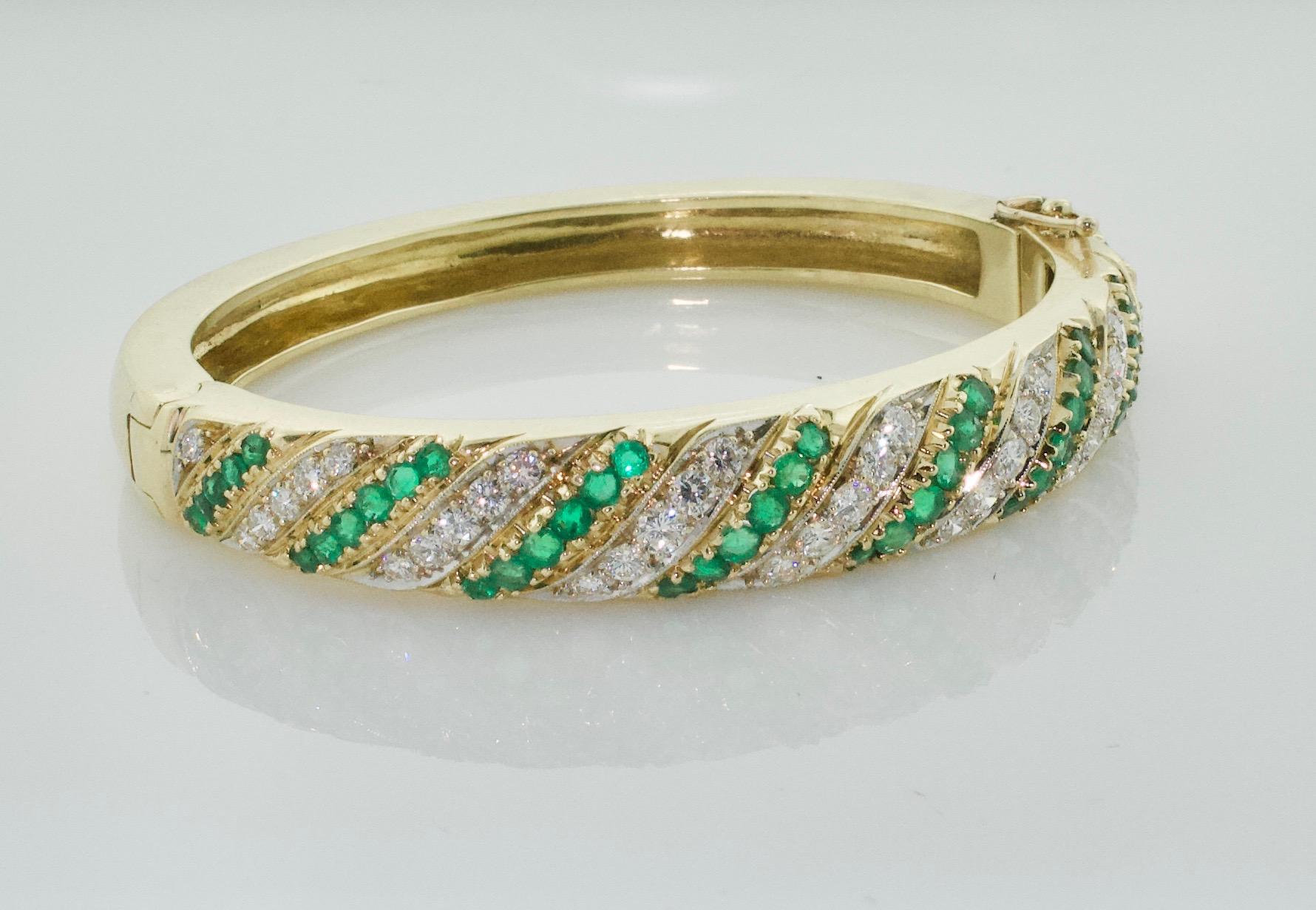 Emerald and Diamond Bangle Bracelet Circa 1960's
containing 37 full-cut diamonds [H-J/VS-SI] weighing approximately 2.15 carats total; and 46 round-cut emeralds weighing approximately 1.70 carats total; 49.4 grams; approximately 6 1/4 inches inner