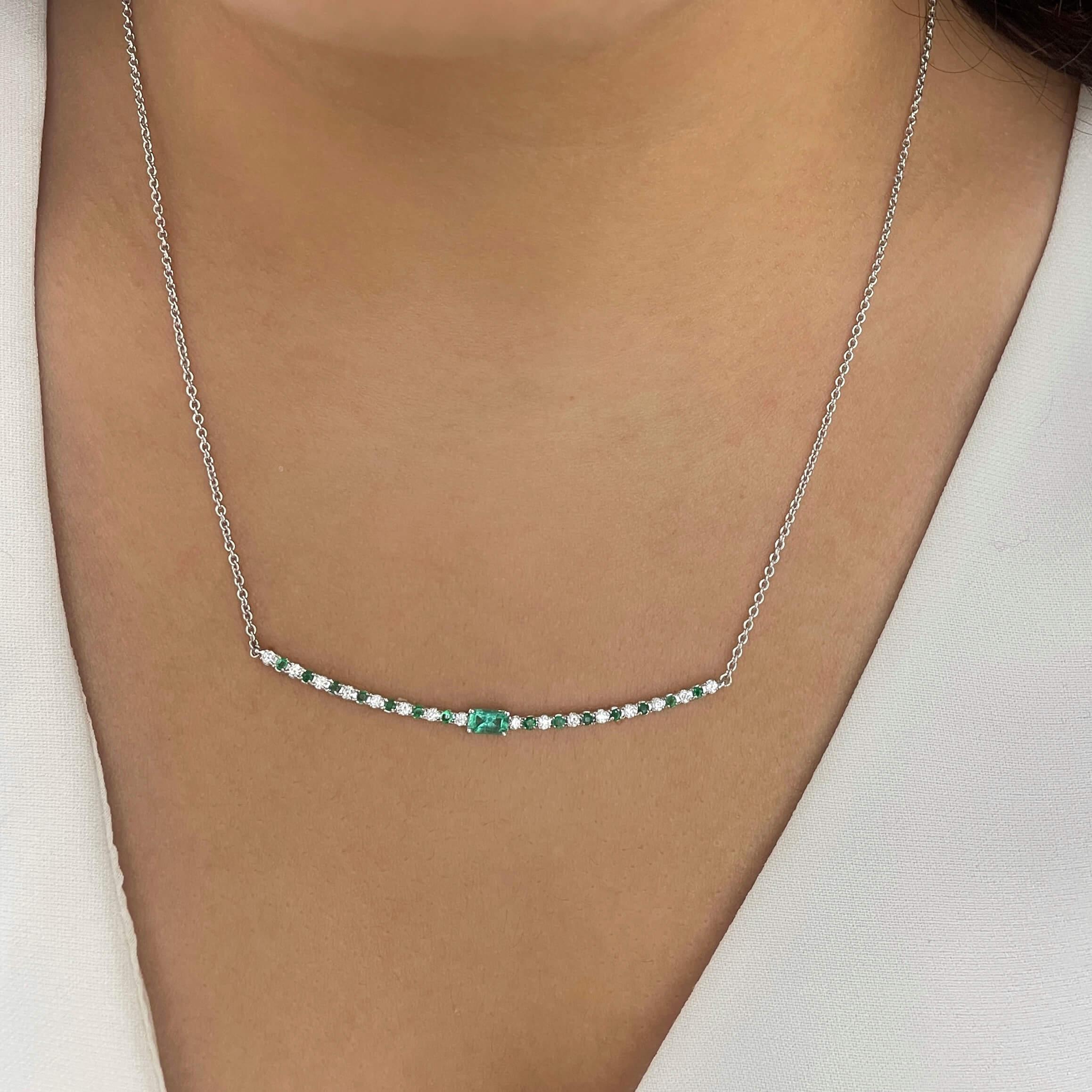 Add a pop of color to your everyday wardrobe with this emerald and diamond necklace featuring a beautiful emerald center stone and alternating round diamonds and emeralds. Available in two center stone sizes, 7x5 and 5x3.

14K White Gold Emerald and