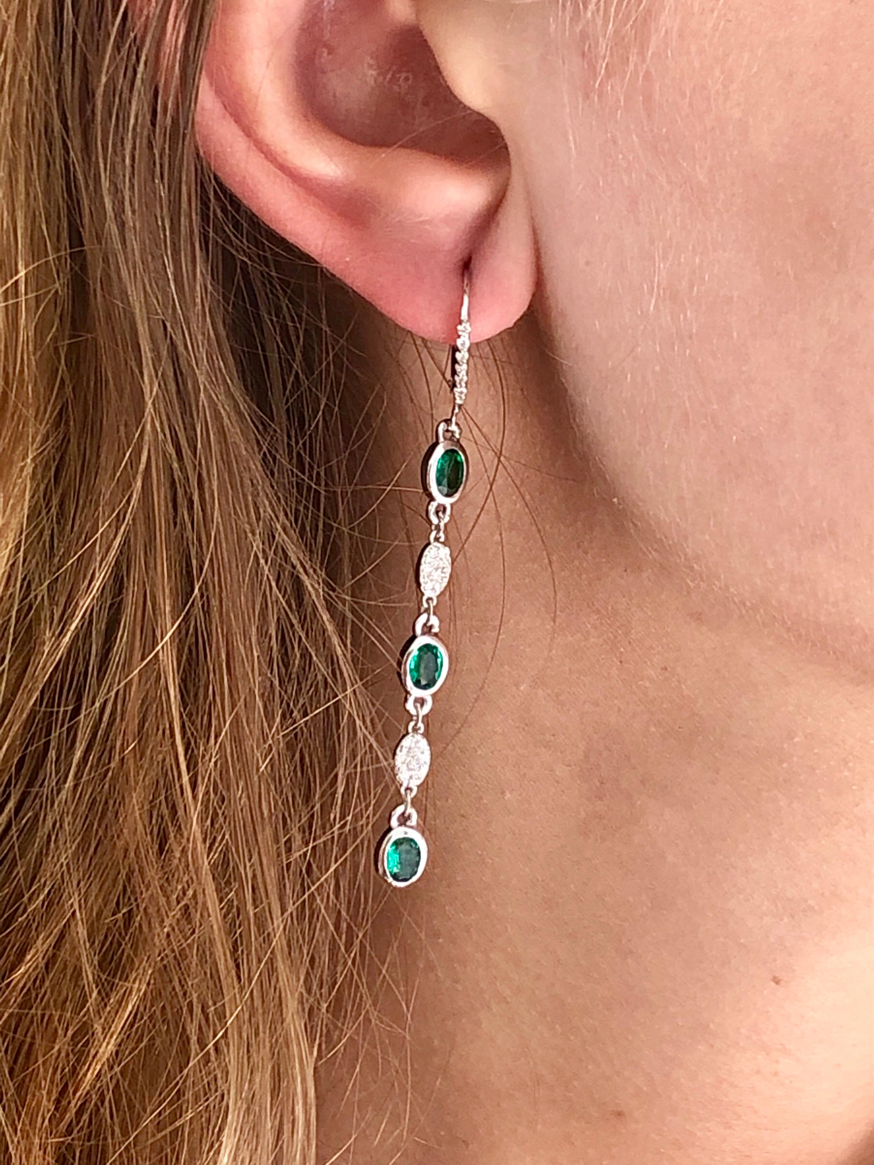 Fourteen karat white gold hoop two inch long drop earrings 
Diamond weighing 0.65 carat
Emeralds weighing 1.75 carat 
One of a kind earrings
Bright, almost flawless and vivid green matched six emeralds
Each emerald weighs 0.30 carat
New