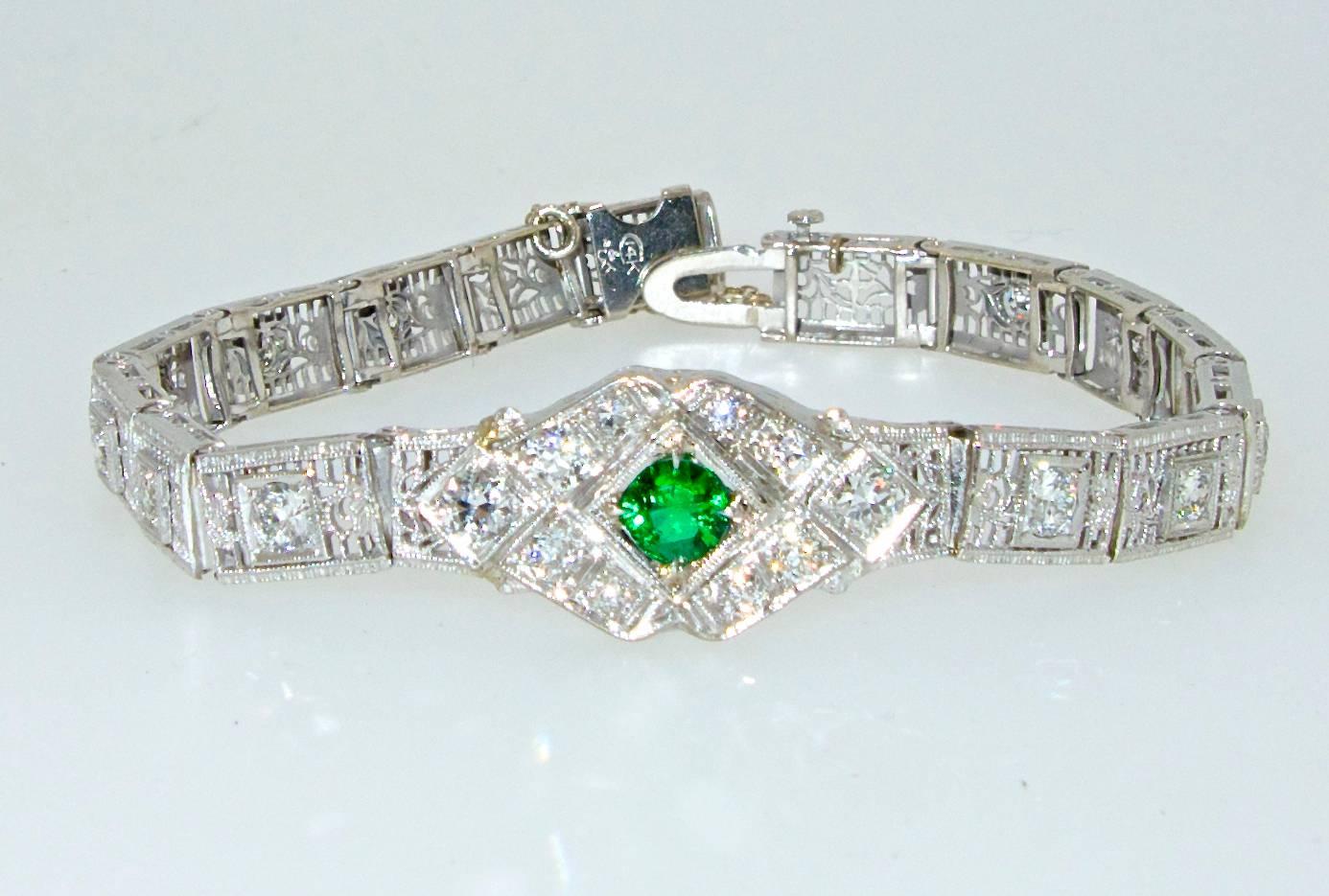 The center emerald is a fine clear bright green natural stone, it weighs .40 cts. The diamonds are all near colorless and very slightly included and weigh approximately 2.0 cts.  This bracelet is both 14K and platinum.