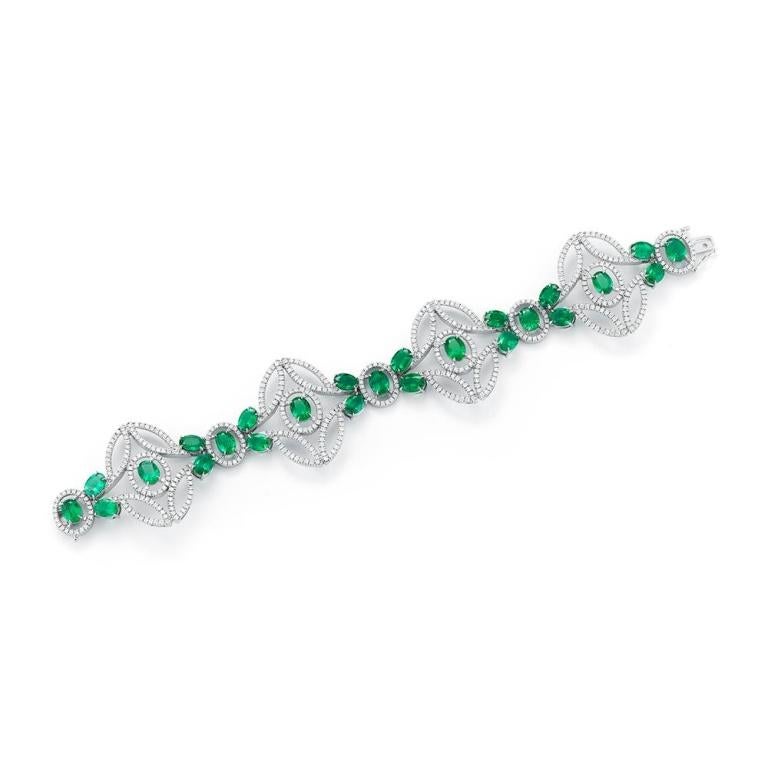 EMERALD AND DIAMOND BRACELET A beautiful airy design with great visual impact features a collection of perfectly matched Zambian emeralds. Item: # 02310 Metal: 18k W Lab: C.dunaigre Color Weight: 23.68 ct. Diamond Weight: 6.61 ct.
