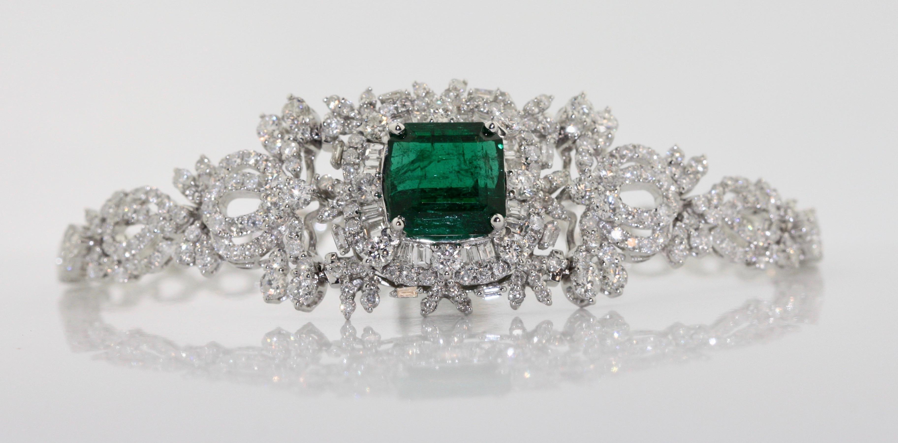 Emerald and Diamond Bracelet 
centered by an octagonal cut emerald weighing 6.44 carats,
diamonds weighing approximately 5.32 carats mounted in 18 karat white gold 
21.8 grams (gross) 
length 7 inches; 
Emerald and Diamond bracelet 
Octagonal Shape,
