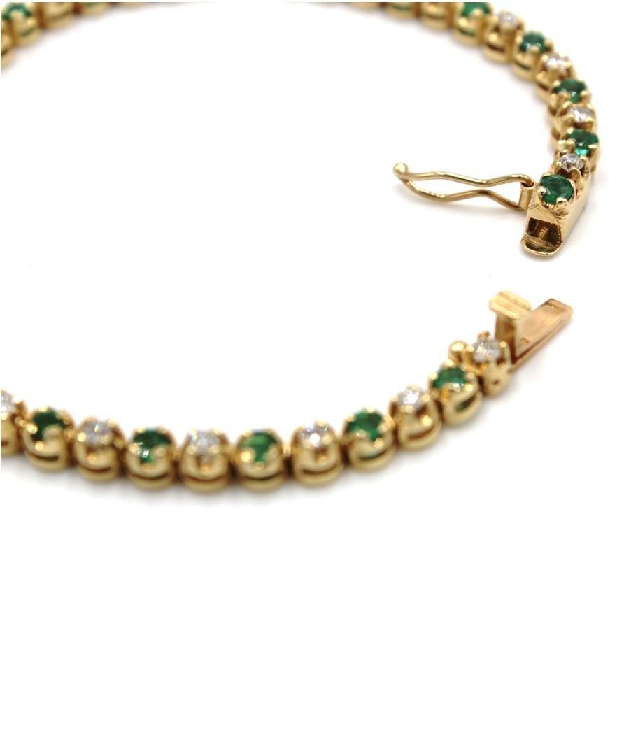 14K yellow gold bracelet with 23 round diamonds totaling 1.15 carats and with 23 round emeralds totaling 2.00 carats.

- 7 inches long