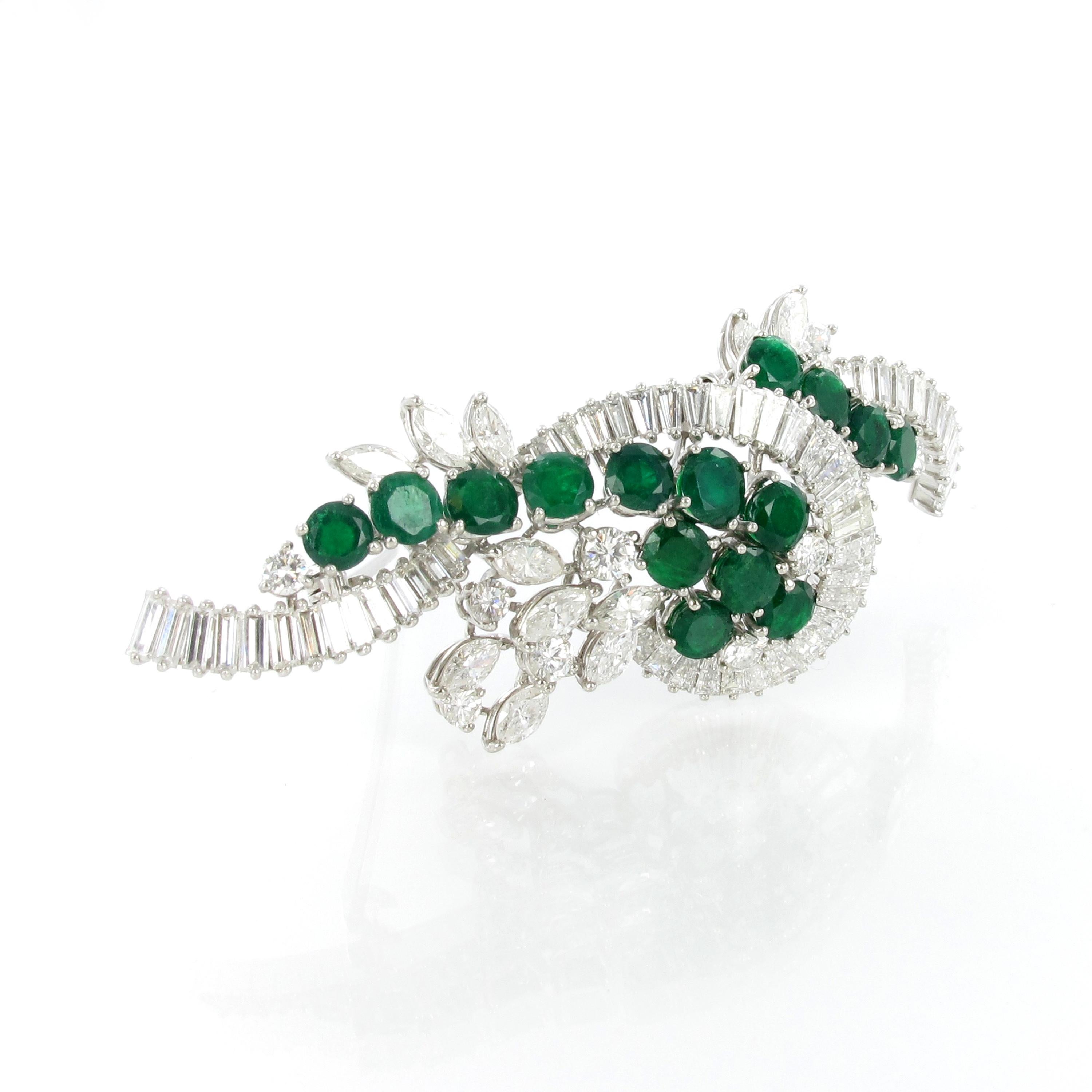Elegant brooch in white gold 750. Set in prongs with 15 round cut emeralds and 75 diamonds of various shapes (round, marquise and tapered cut). Total weight of the emeralds approximate 3.40 ct, total weight of diamonds approximate 5.94