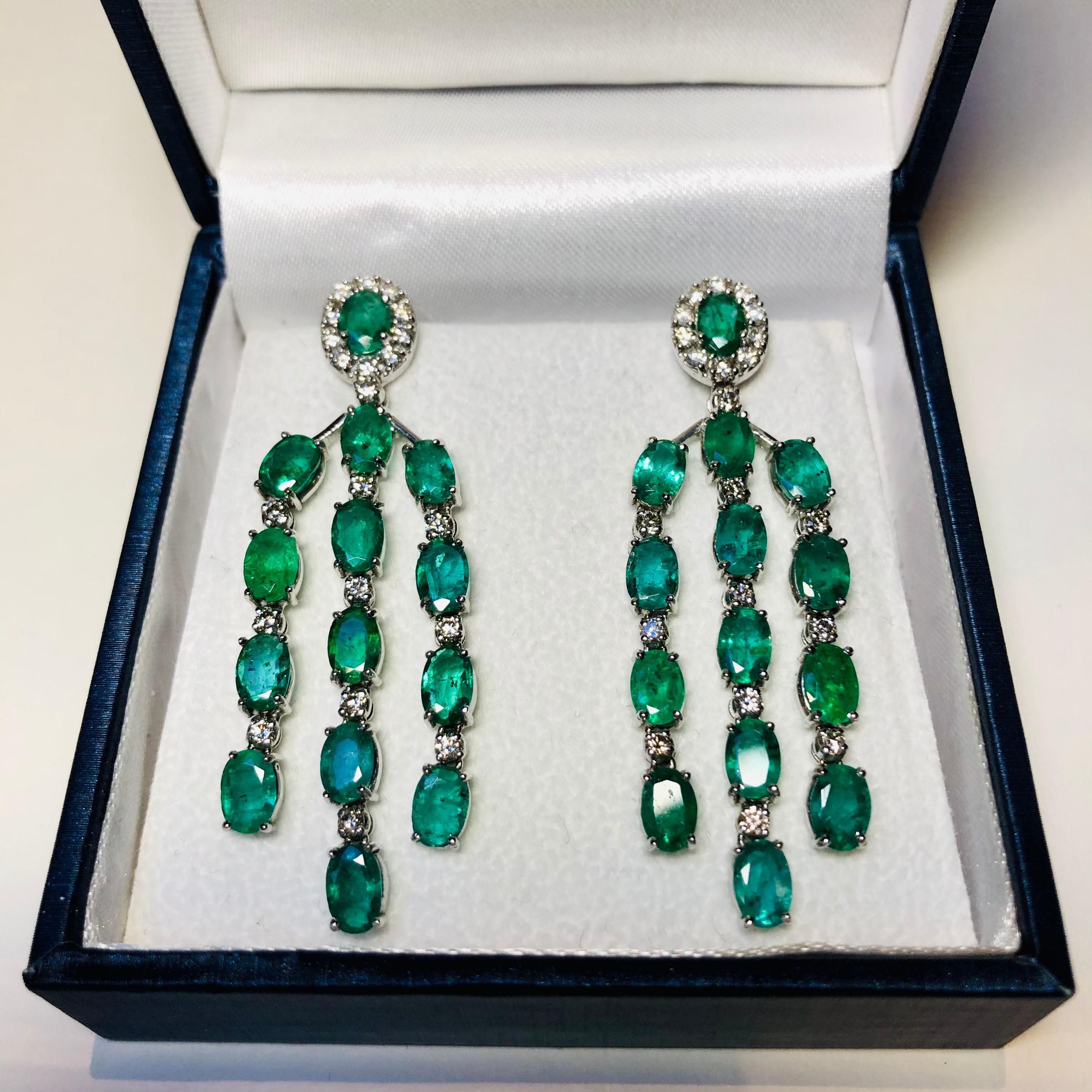 Emerald and Diamond chandelier earrings set in 18 carat white gold. Boasting 7.8 carats of oval cut emeralds and 1.60 carats of brilliant cut diamonds in an articulated white gold setting. Elegant and refined these earrings are Red Carpet worthy but