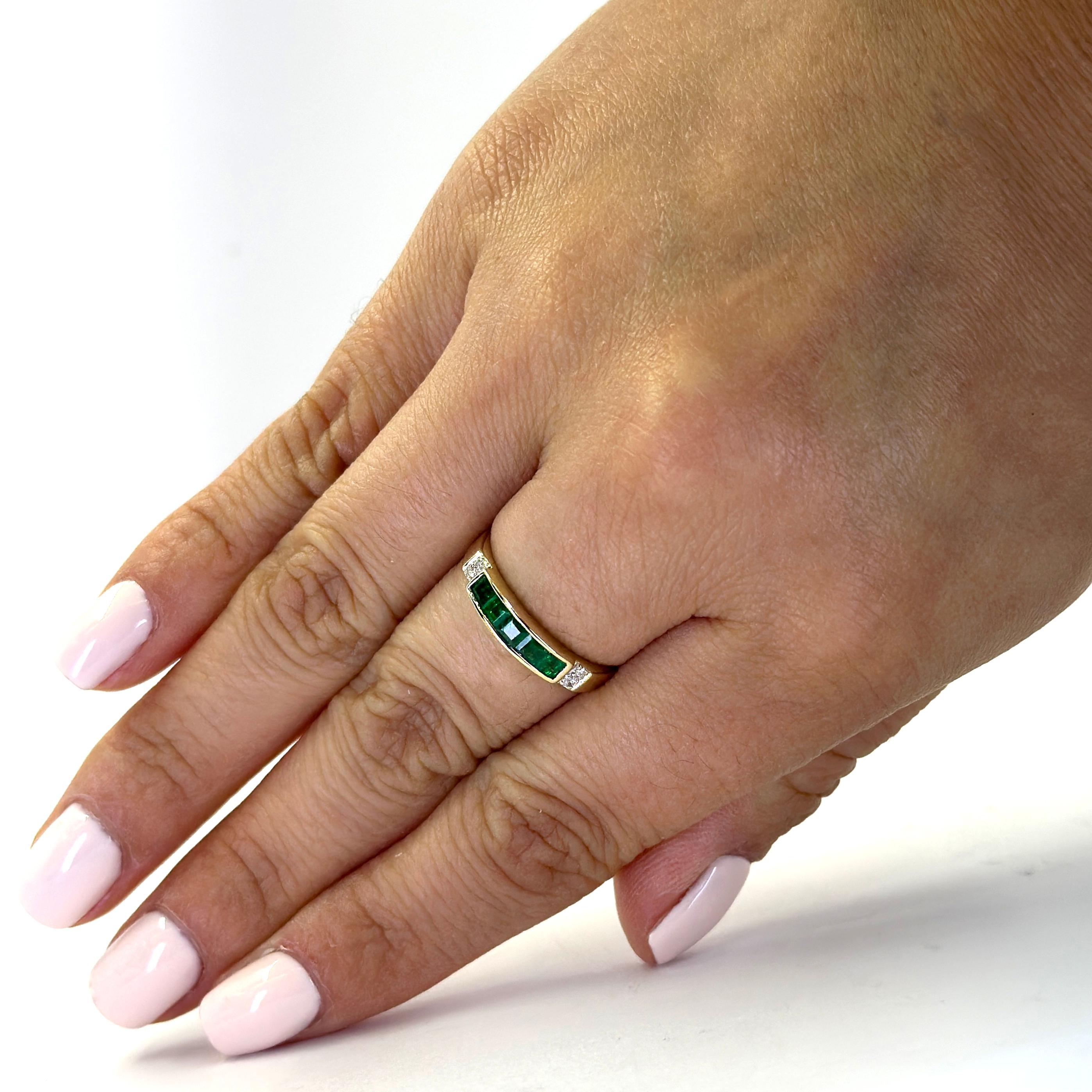 14 Karat Yellow Gold Band Featuring 5 Emeralds Totaling Approximately 0.50 Carats Accented by 4 Round Diamonds of SI Clarity and H Color Totaling 0.02 Carats. Finger Size 7. Purchase Includes One Sizing Service Upon Request, Prior to Shipping.
