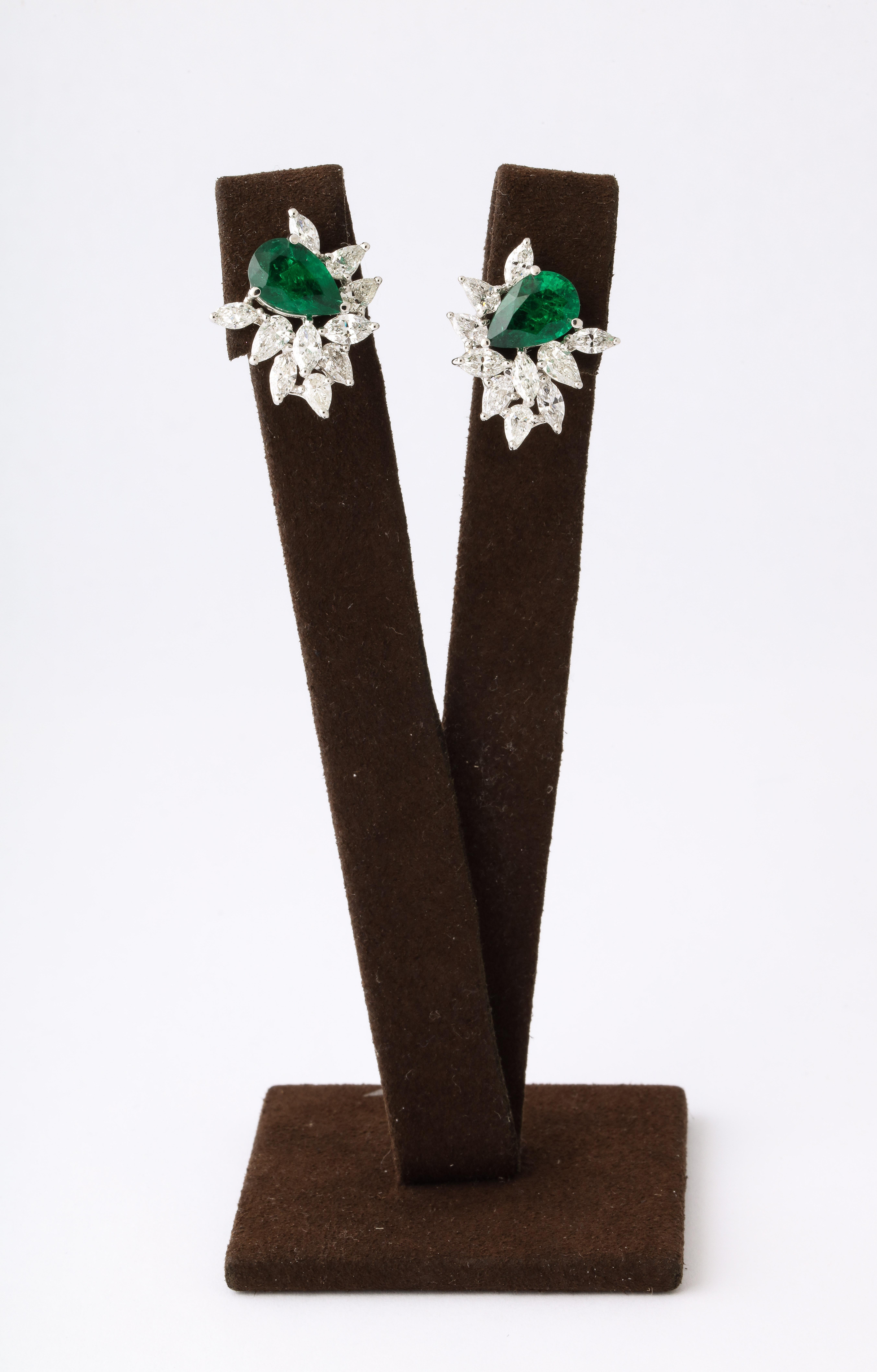 
A fashionable pair of emerald and diamond earrings. 

4.95 carats of certified “VIVID GREEN”Emeralds. 

4.21 carats of white pear and marquise shape diamonds. 

Set in 18k white gold. 

Just under 3/4 of an inch wide and tall, approximately. 

A