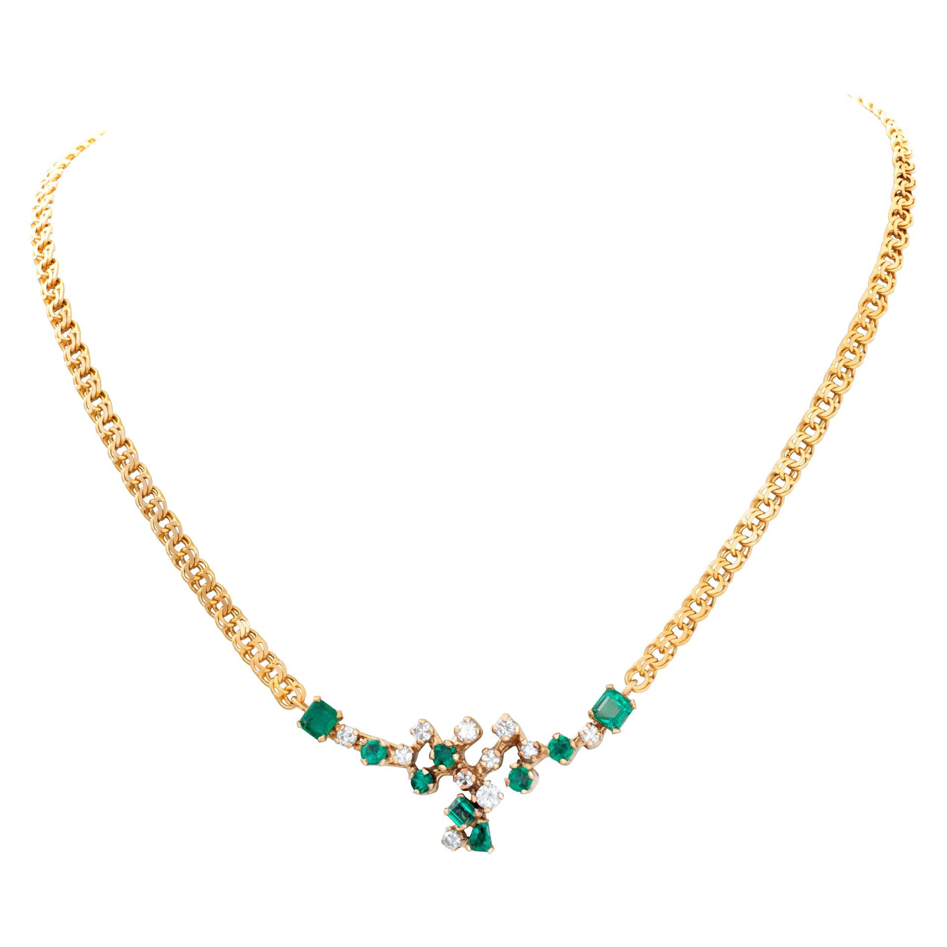 Emerald and diamond cluster necklace set in 18k yellow gold. Total carat weight 1.5 carats in G-H color, VS-SI clarity diamonds and 2.2 carats in emeralds. Length 16