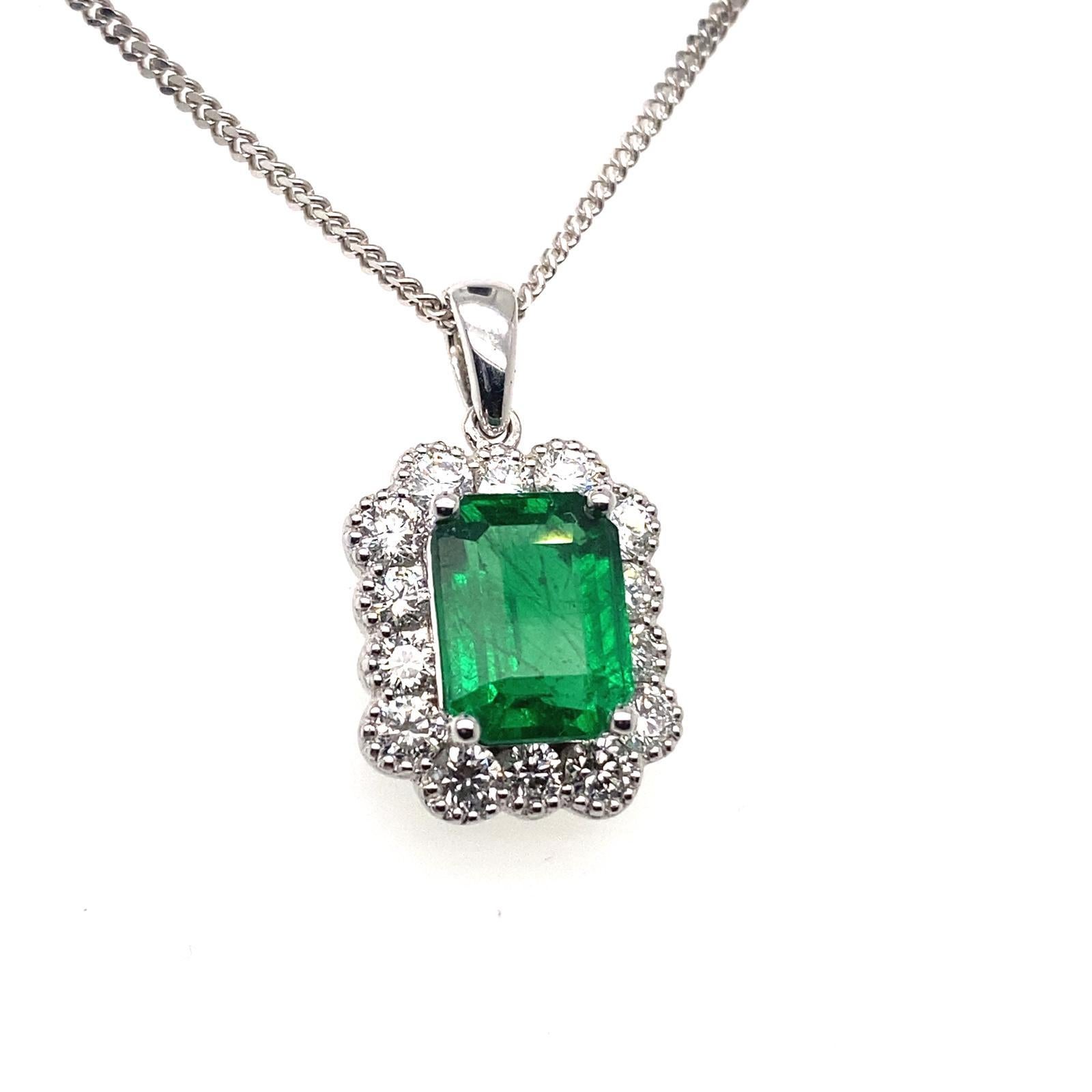 An emerald and diamond cluster pendant in 18 karat white gold.

Designed as a classic emerald cut emerald and diamond cluster.

This contemporary pendant features a deep green emerald cut emerald with a known weight of 1.76cts within a halo surround