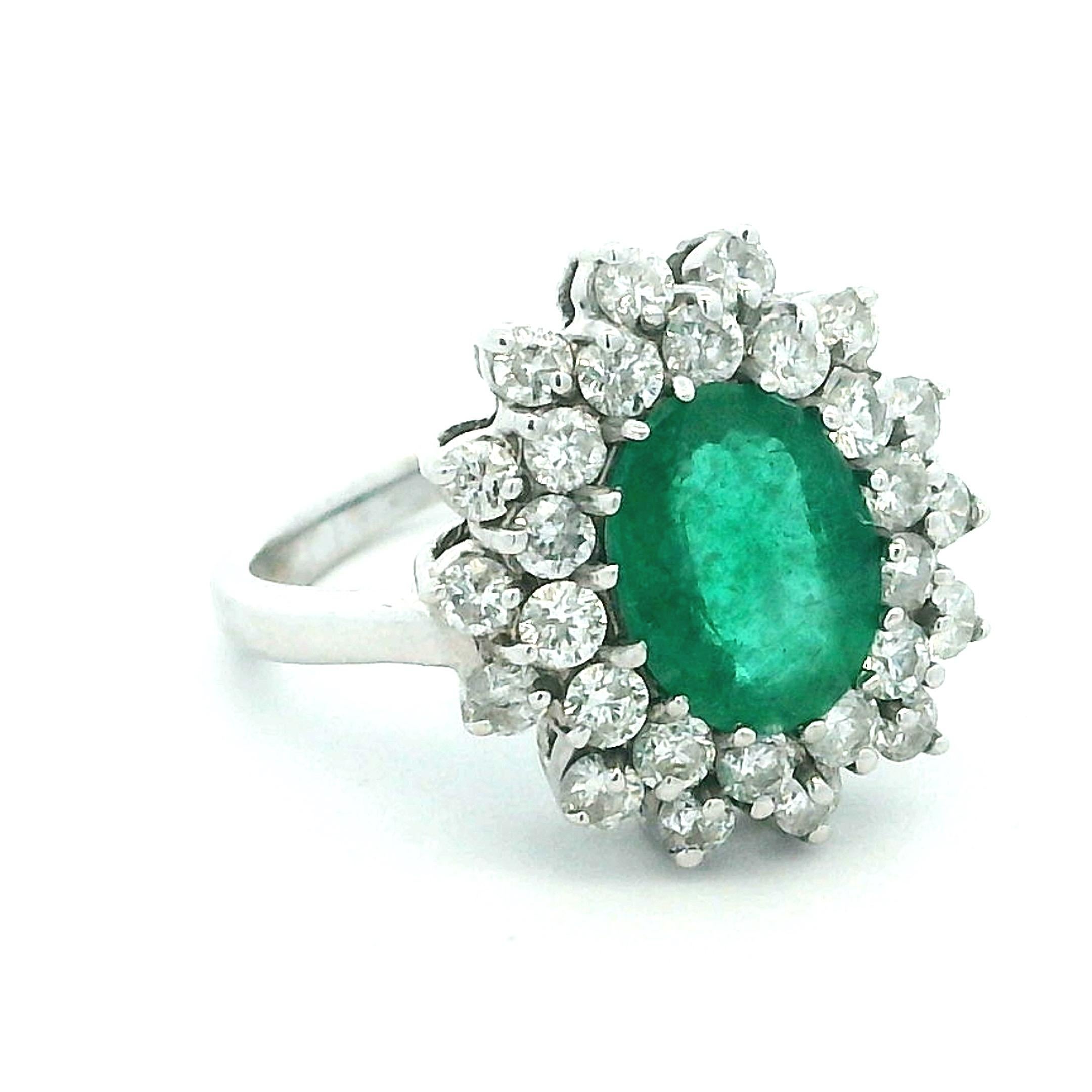 Una classica Silhouette a grappolo con un cuore vibrante.
Al centro di questo anello c'è uno smeraldo da 1,25 carati riccamente saturo, brillante e inconfondibilmente vivo, incorniciato da un'aureola di diamanti bianchi scintillanti per un totale di